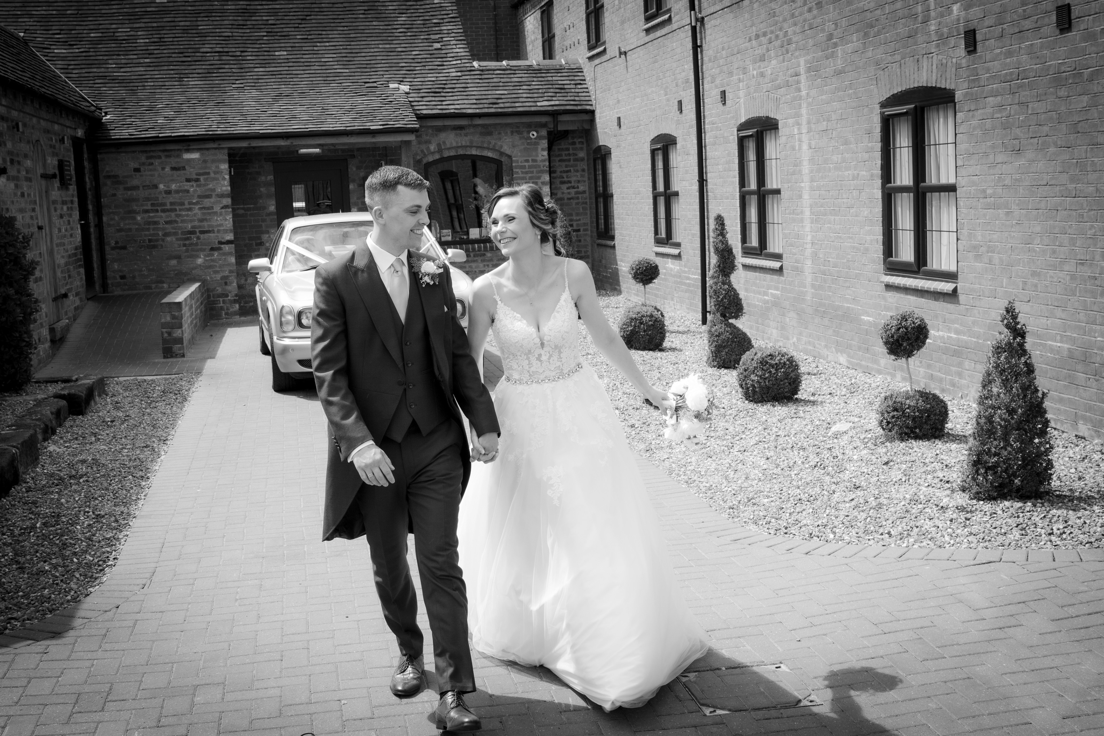 Bride and groom walking by The Multi Media Market Wedding Photography in Dudley.
