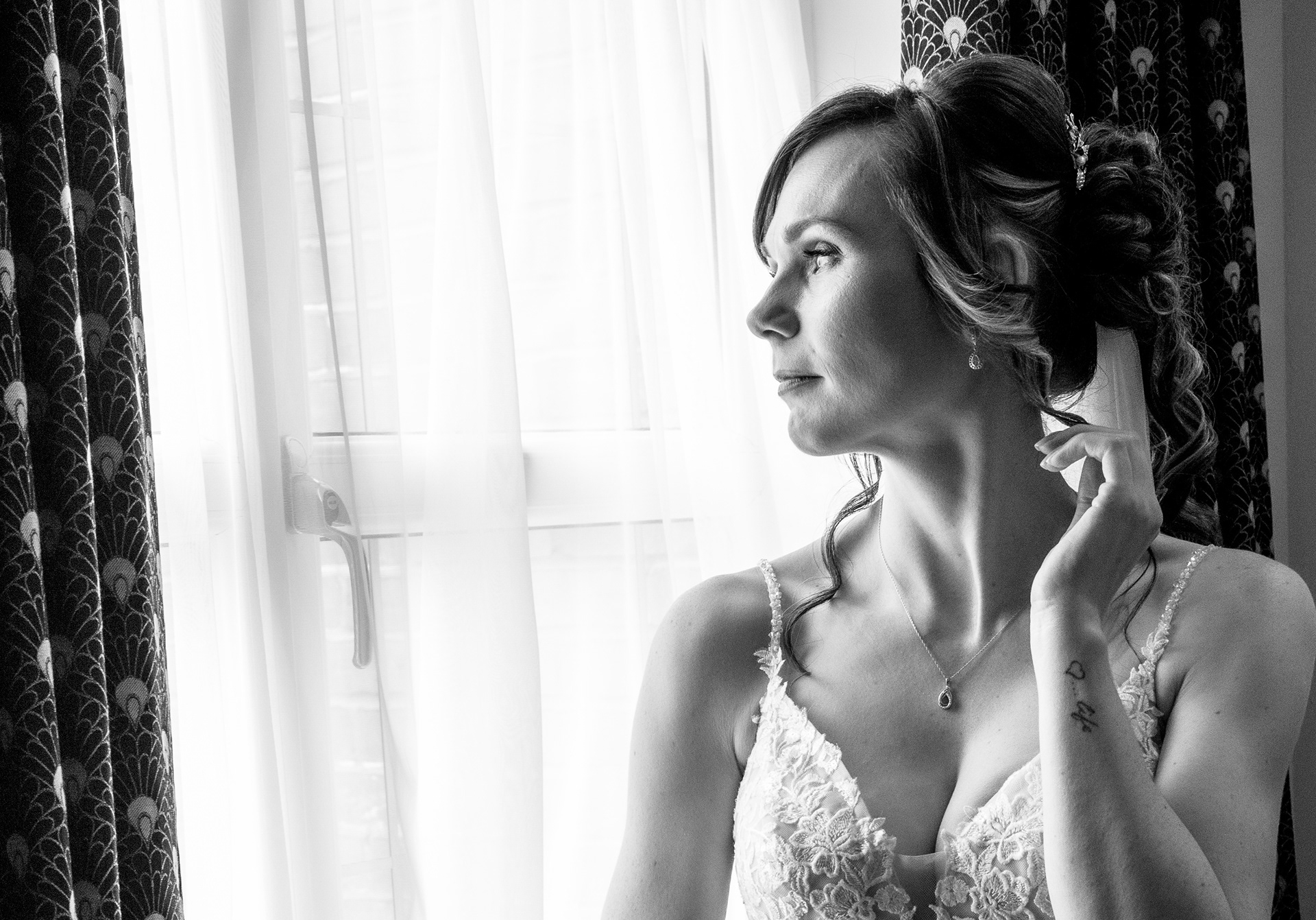 Bride gazing out of window y The Multi Media Market Wedding Photography in Dudley.