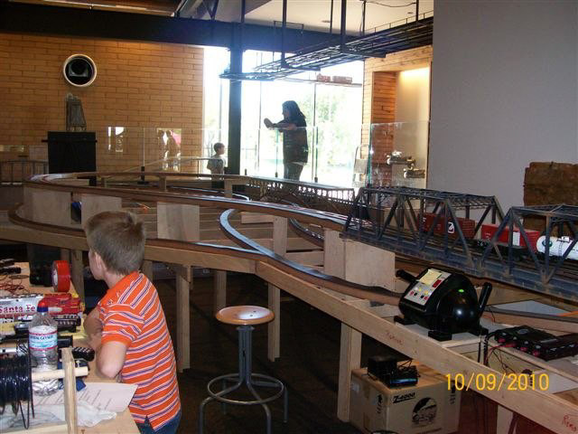 Christopher watches his trains charge around the loop.