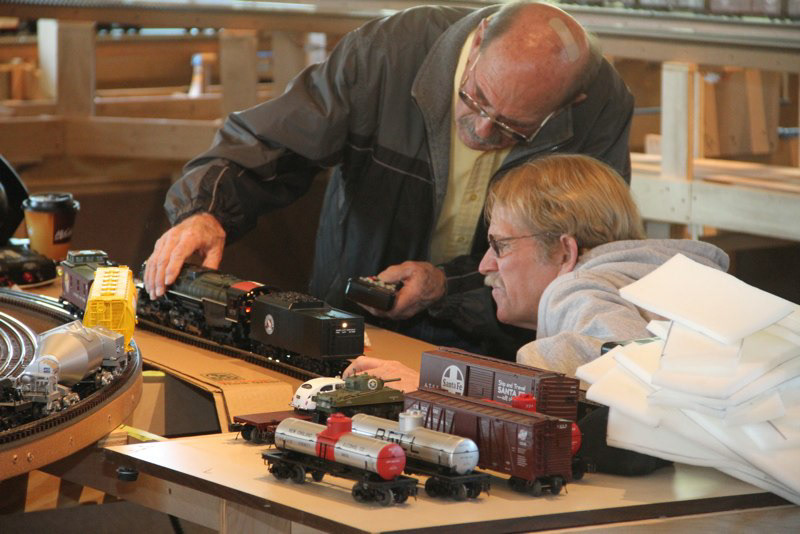 Engine problem solving team Bill Rodgers and John Biely concentrate on Johns.