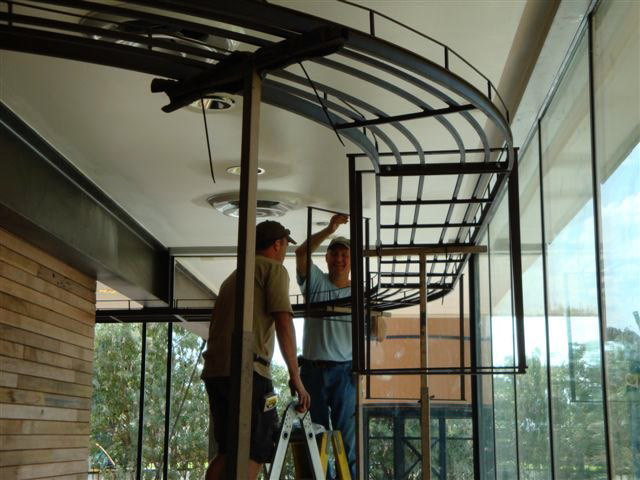 Dan Hoag and his assistant install the G gauge twin loops that circle the lobby.