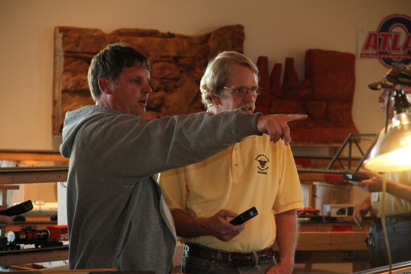 Loren and John discuss strategy and solve problems as the opening draws neigh.