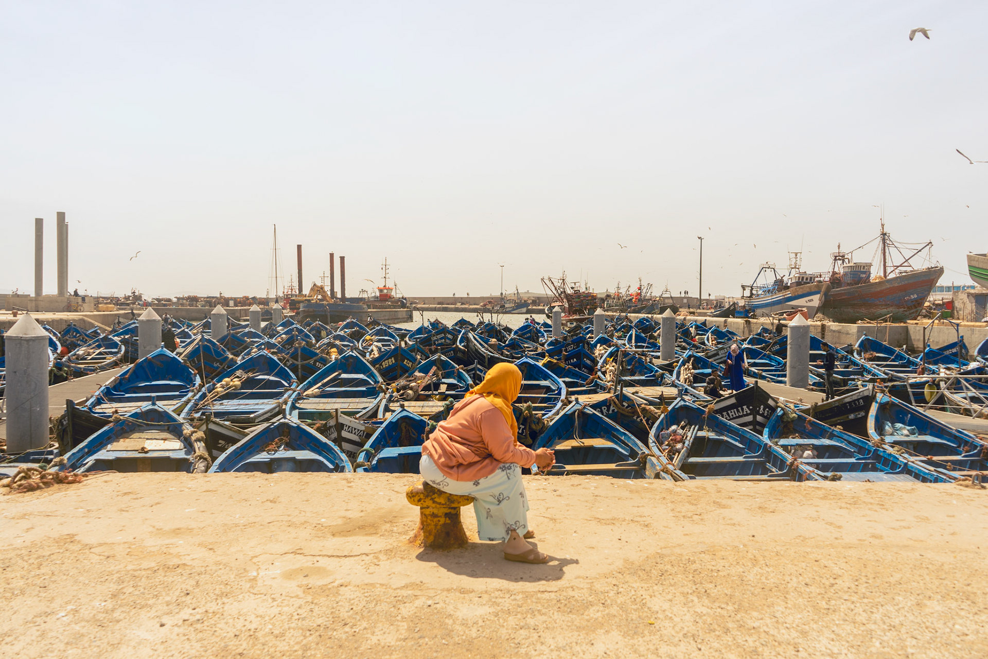 a woman sits at the port