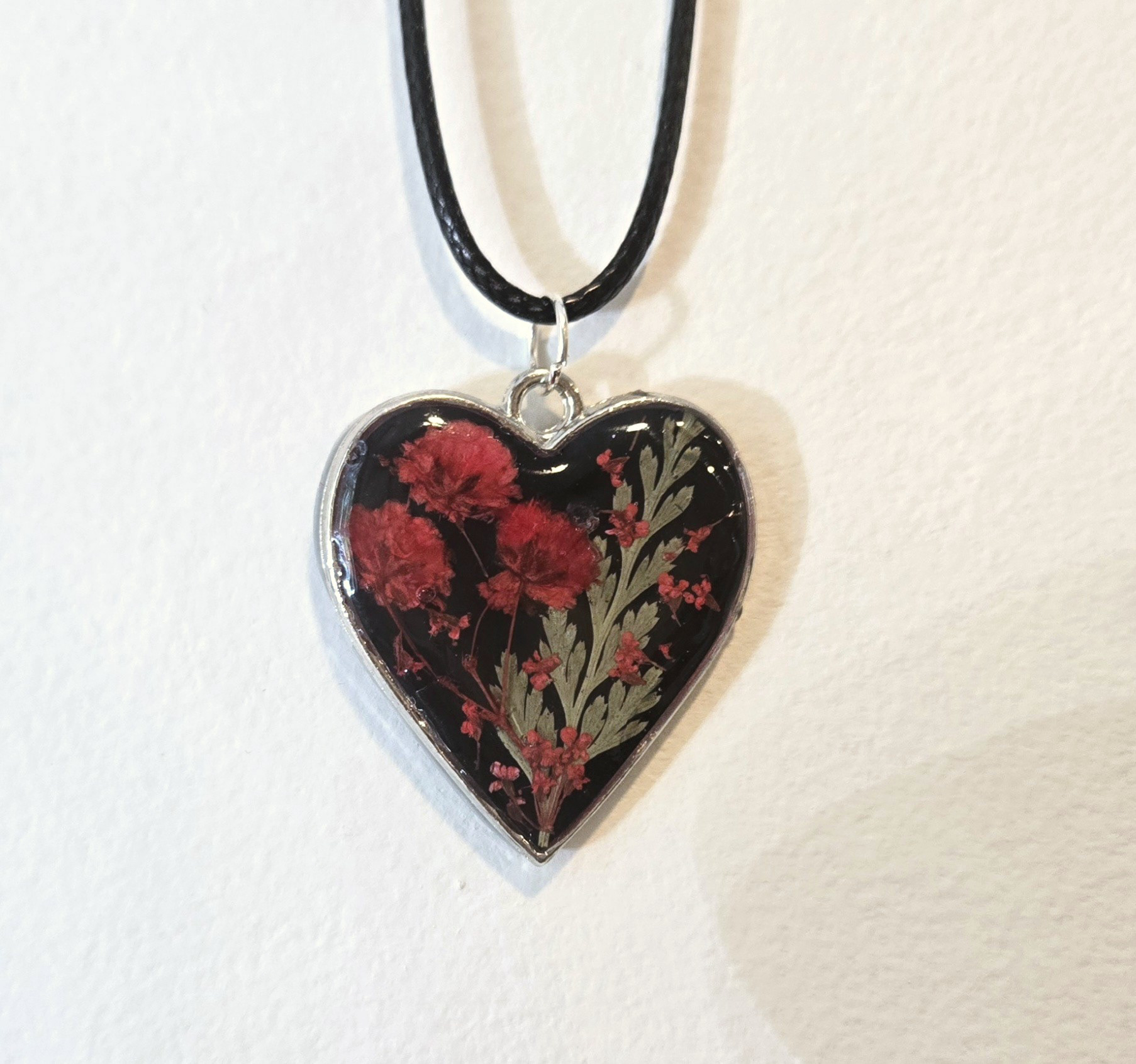 8. red flowers in black heart, silver frame