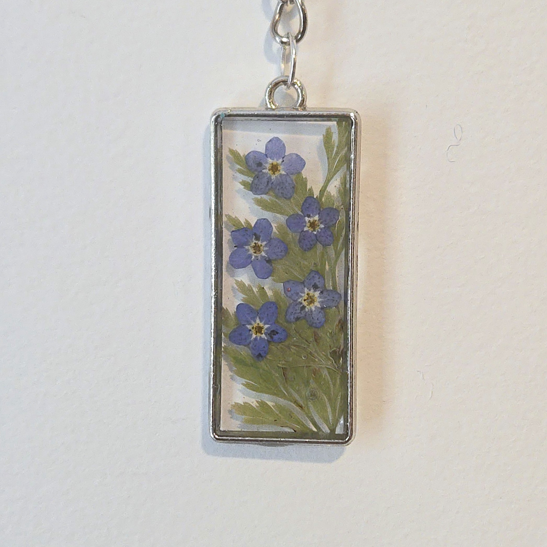21. forget-me-not garden in clear rectangle, silver frrame