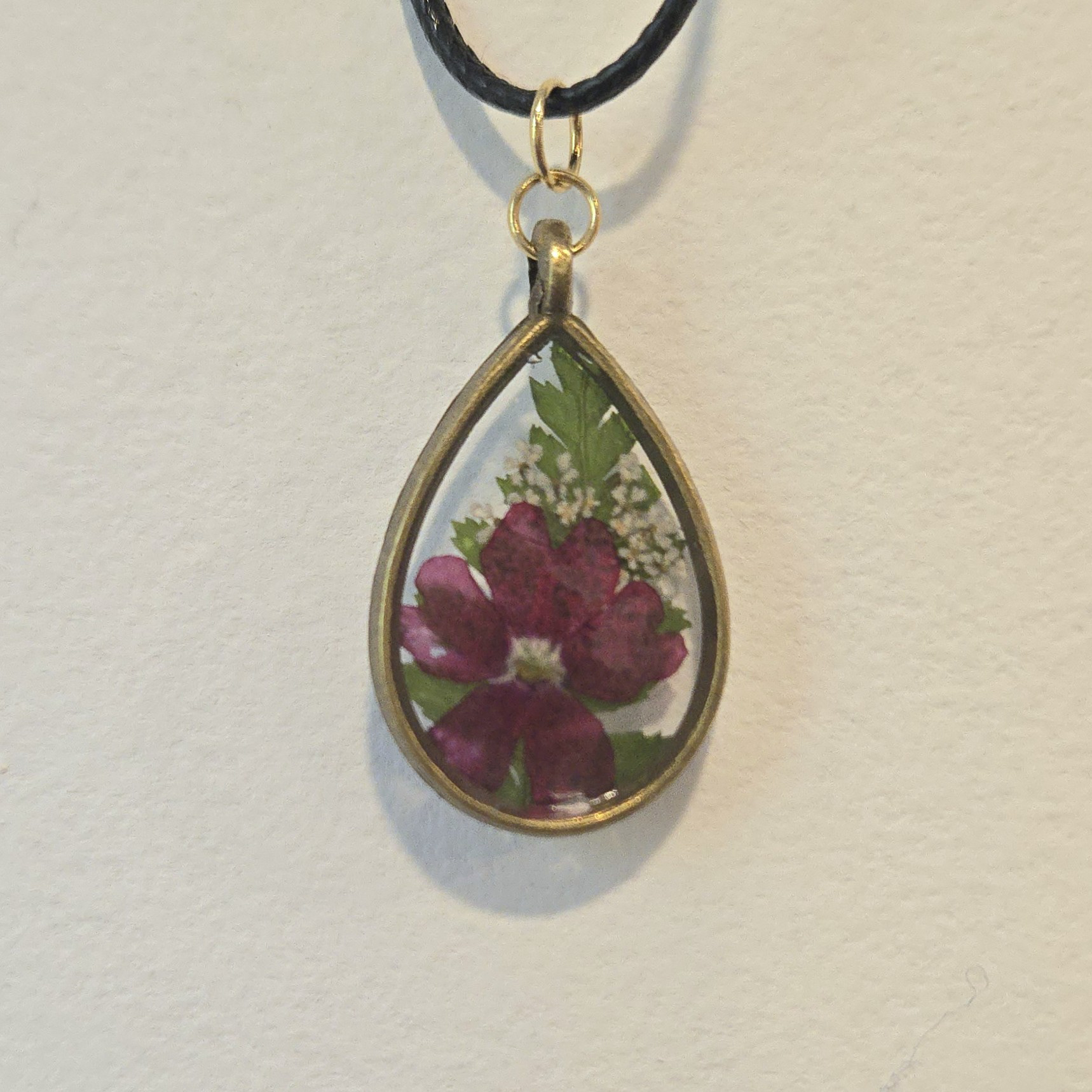 28. burgundy flower in clear teardrop, antique frame