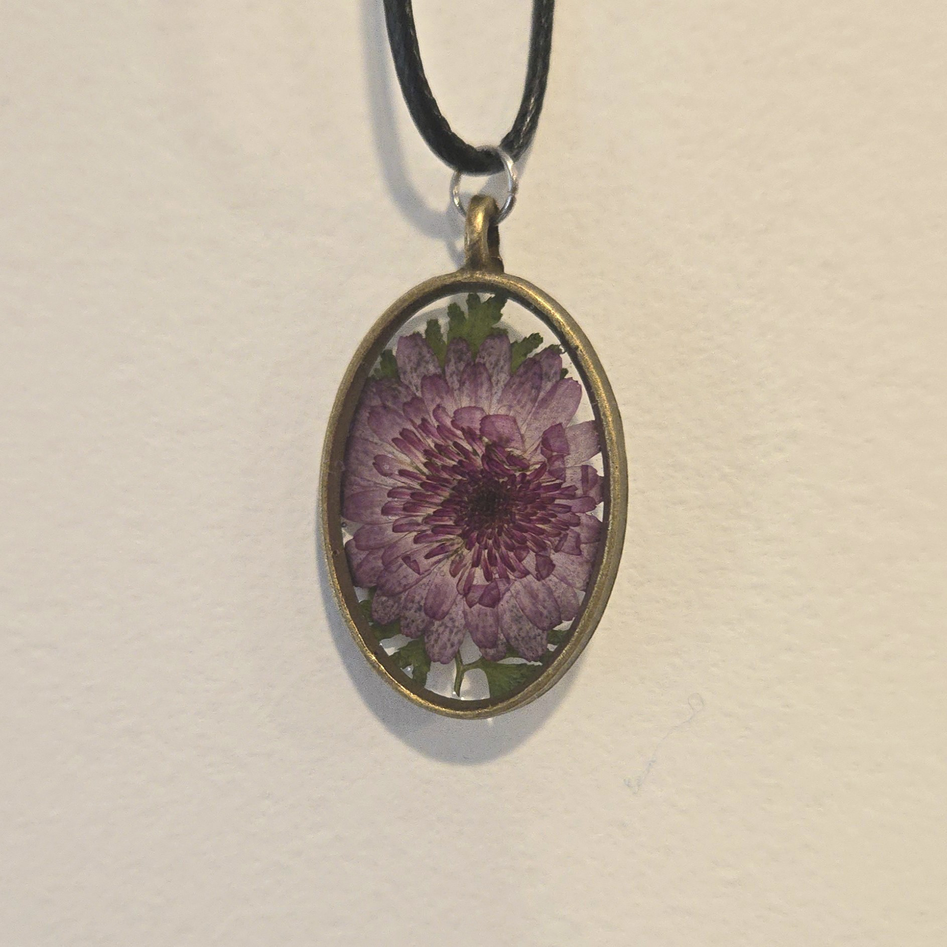 32. purple flower in clear oval, antique frame