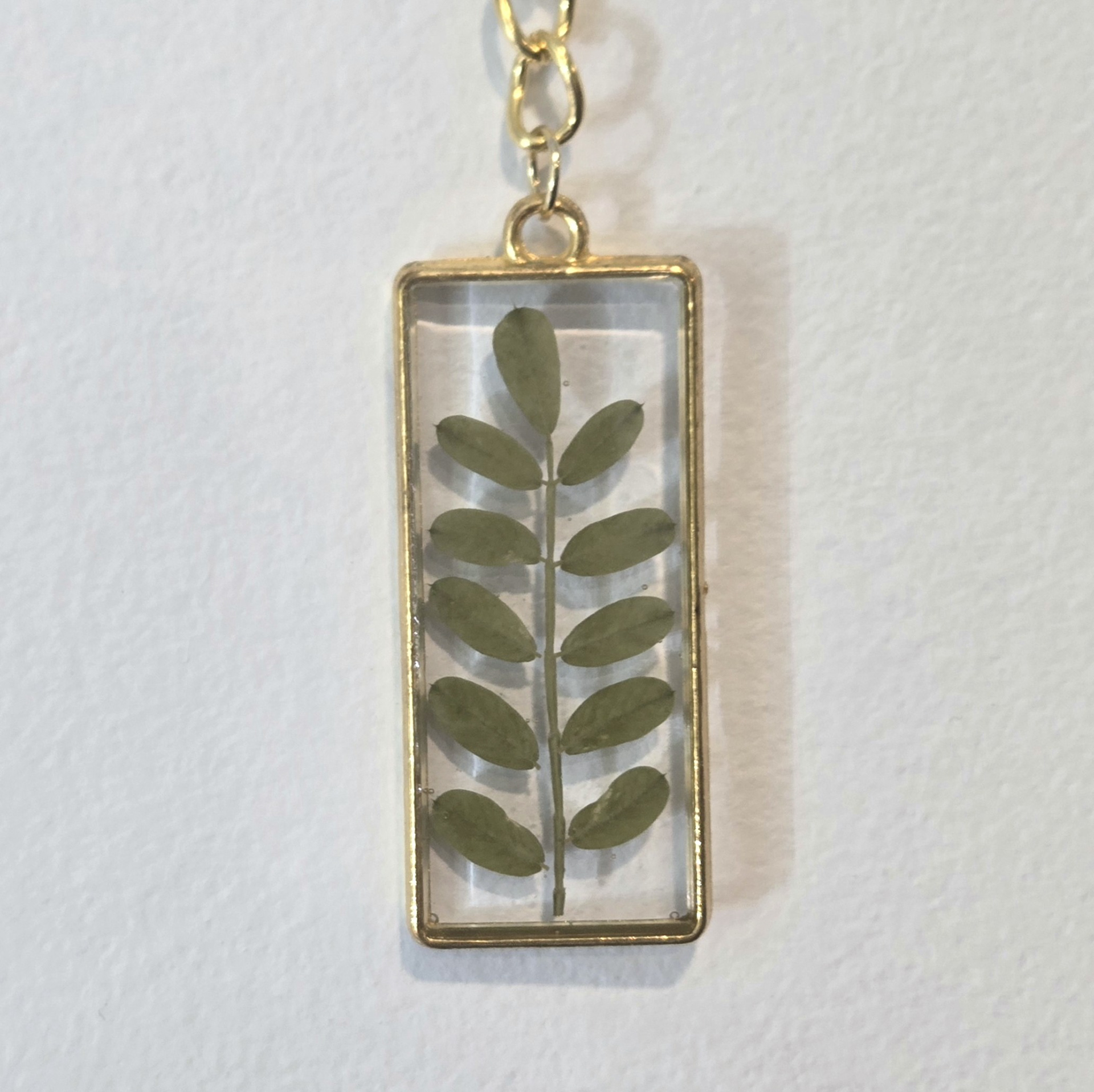 9. leaf stem in clear rectangle, gold frame