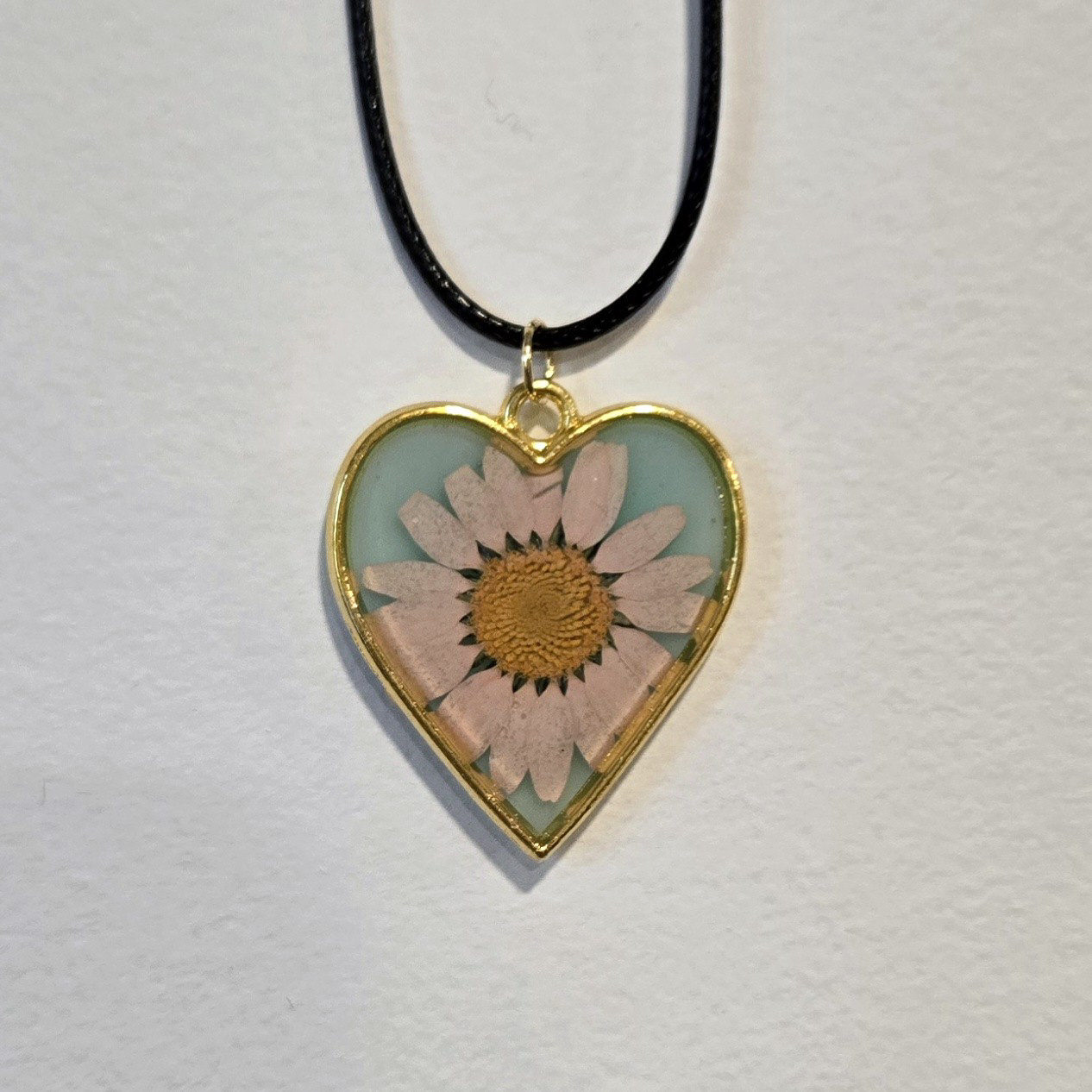 11. pink daisy in aqua heart, gold frame
