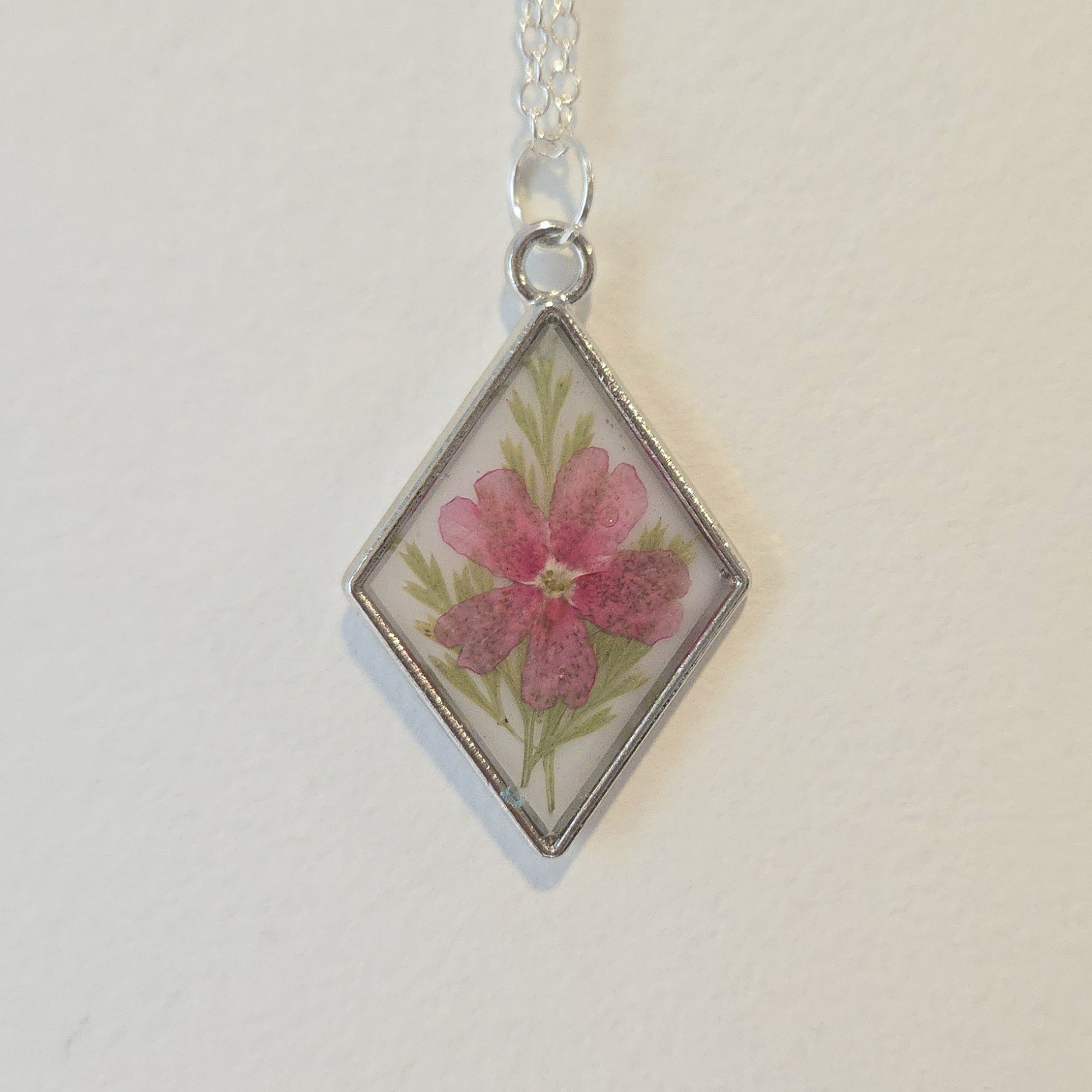 30. pink flower in white diamond, silver frame