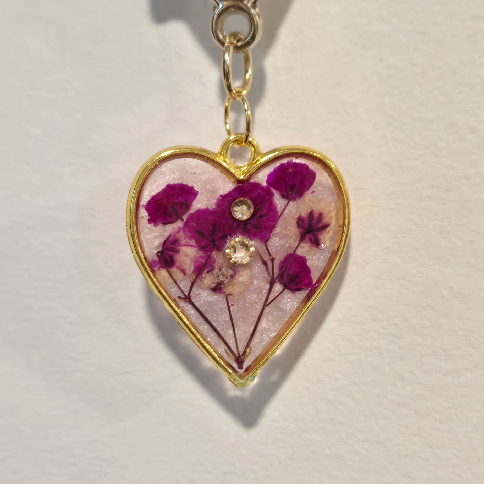 18. fuschia flowers in light pink pearlescent heart, gold frame