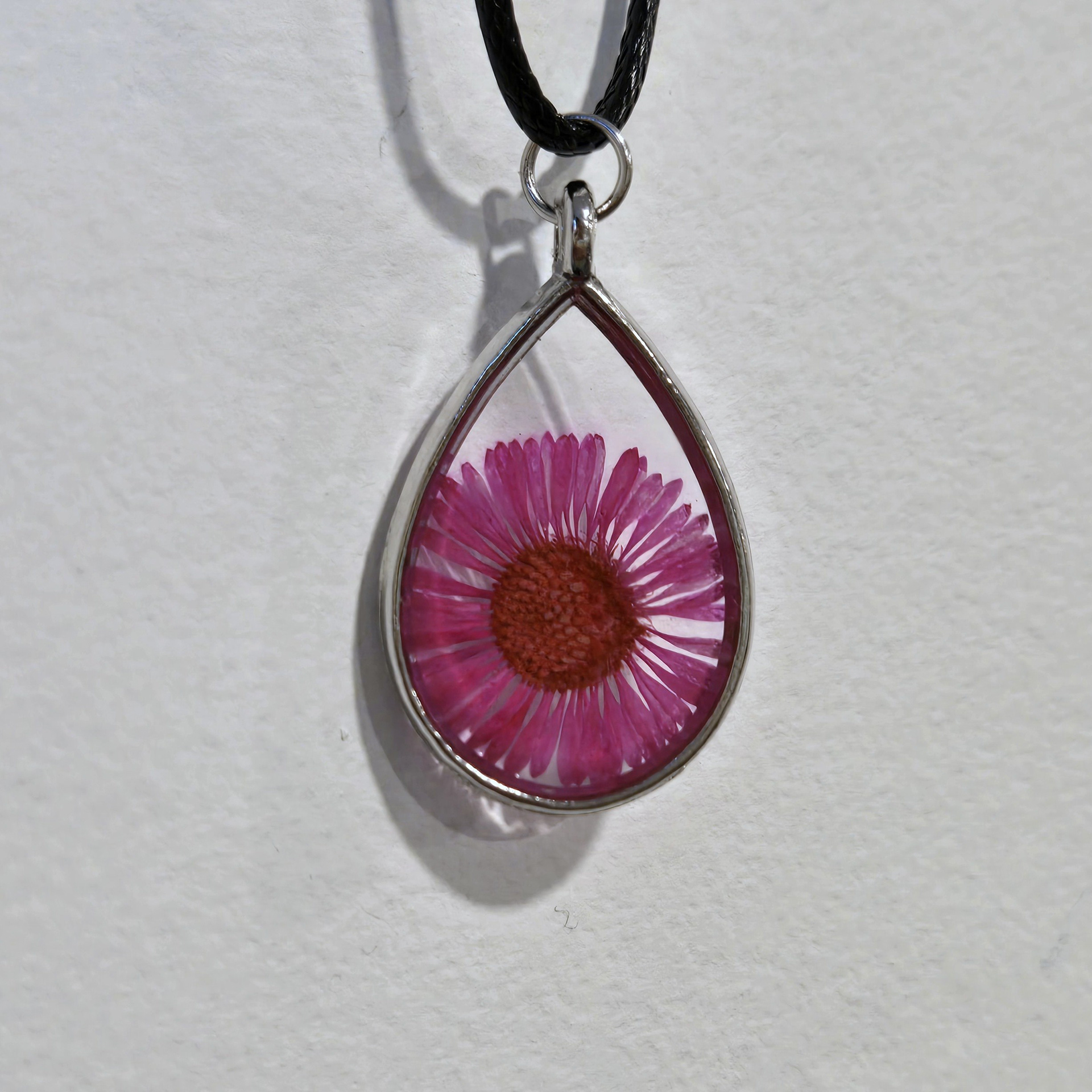 17. fuschia flower in clear teardrop, silver frame