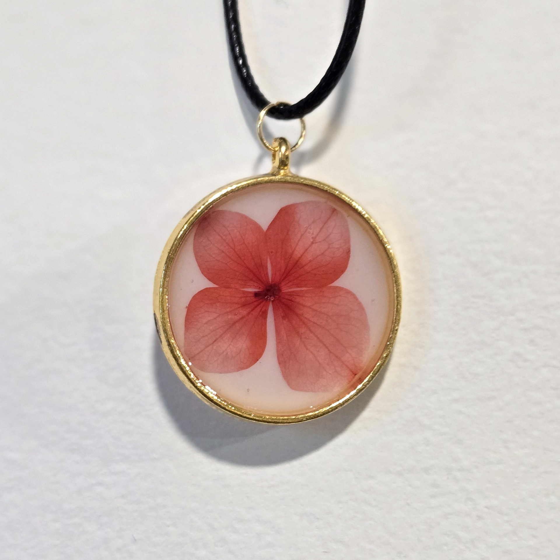 16. red flower in white circle, gold frame