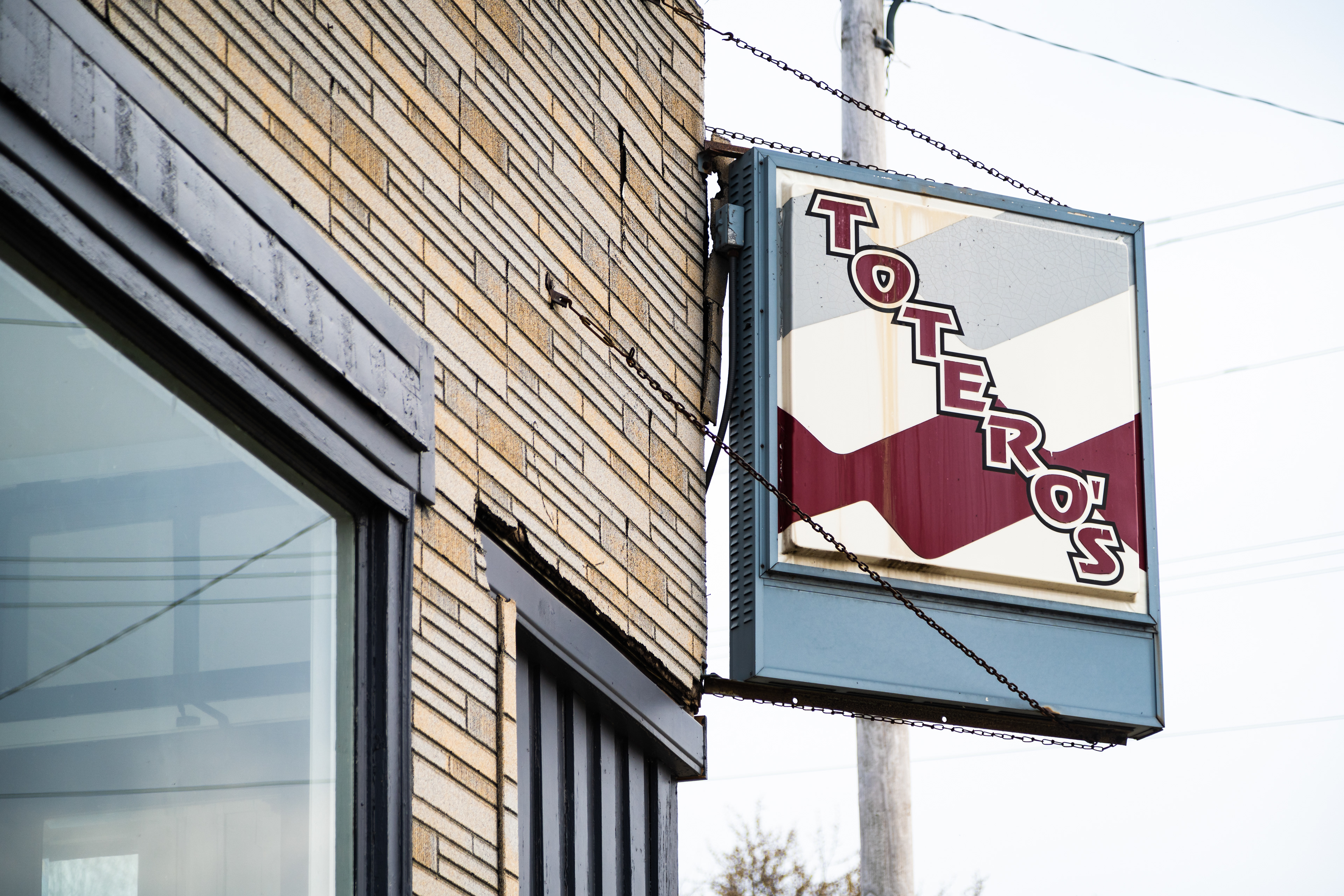 The timeworn Totero’s sign, one of the final reminders of the once beloved local Italian staple, is pictured at 2343 Mead St in Mount Pleasant, WI on April 23, 2021. After 75 years of service, the Totero family closed its doors in 2014. In 2021, Sap-Sap hopes to bring life back to the building. (Photo by Brian Huynh)