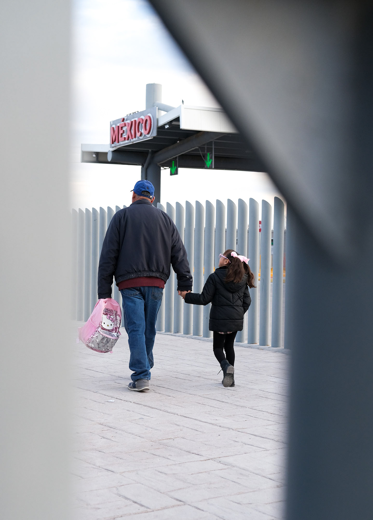 A girl and her father cross the border into the US to catch the school bus. She's one of dozens of Mexican-American students that cross daily to go to public school in Columbus, New Mexico. Palomas, Chihuahua