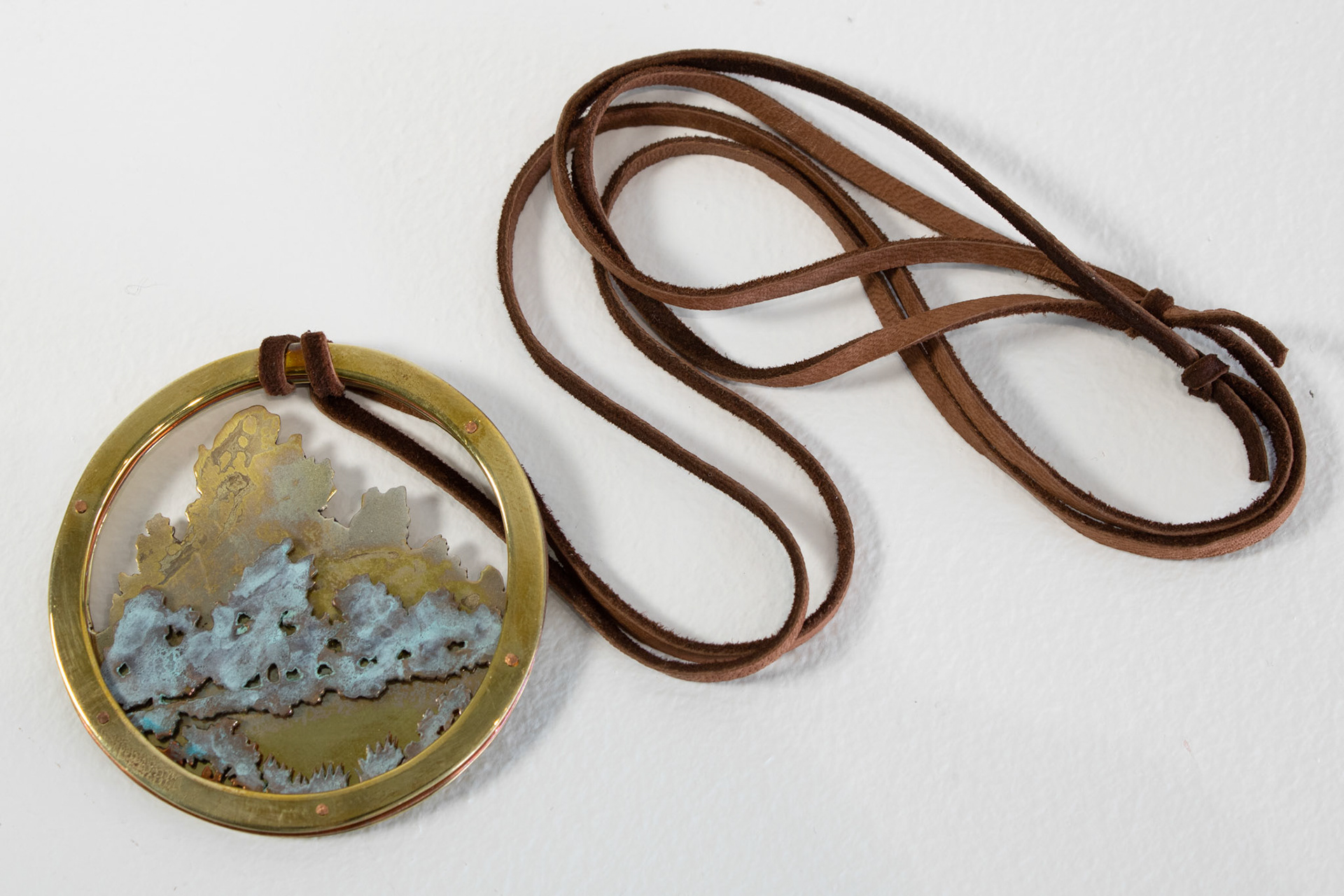Landscape Amulet, 2022, copper and brass.