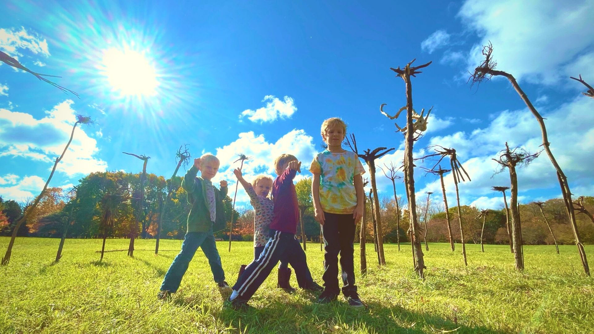 Kids standing in Hawthorn Hollow Tree Root Installation by Sinclair Myhre