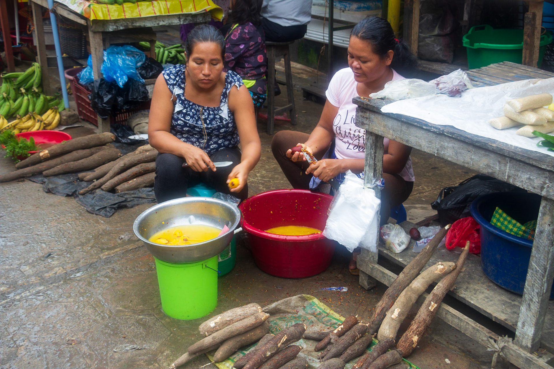 Ladies prepping food for grill selling taro roots