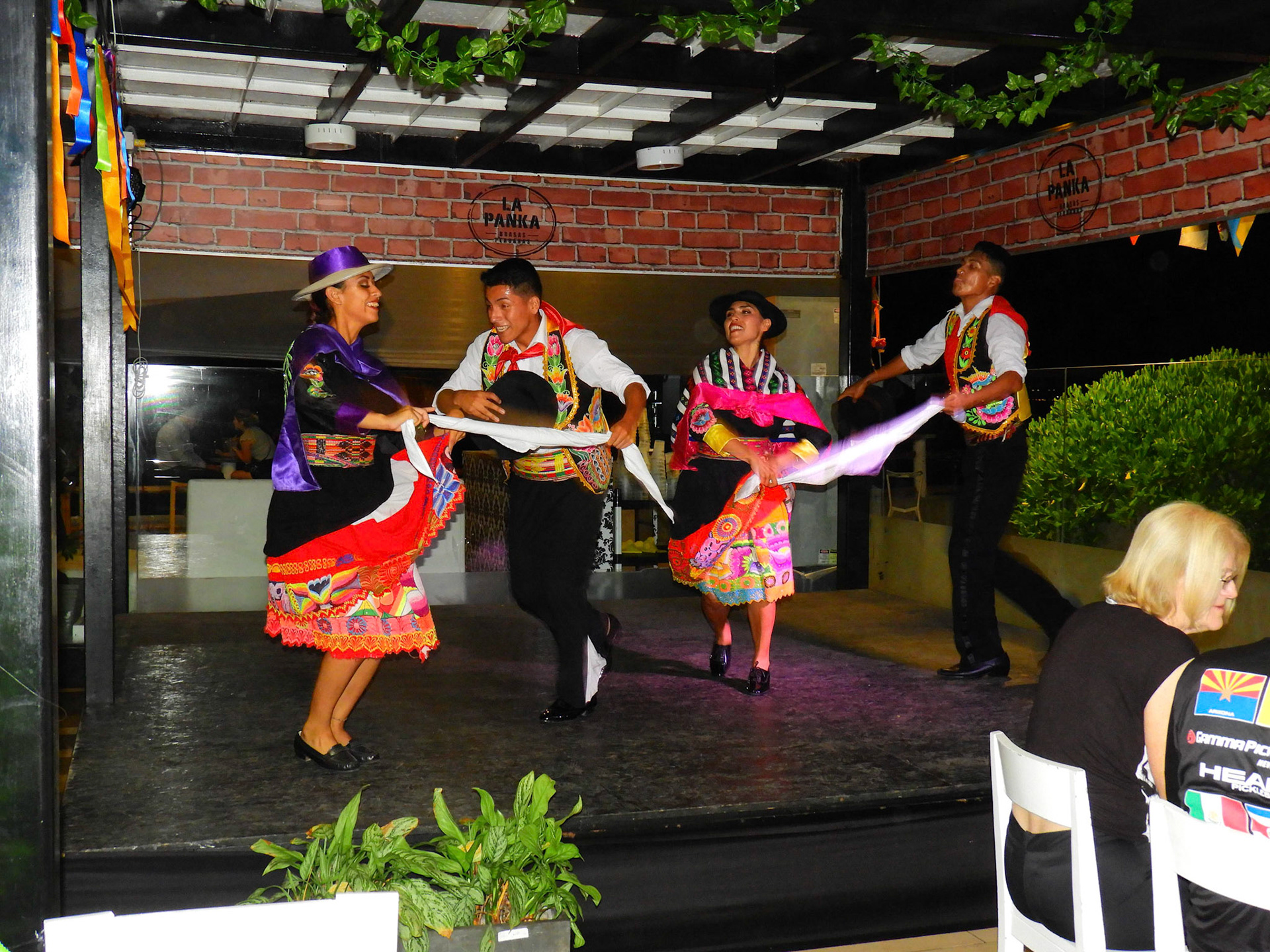 Dinner and folk dances at a restaurant on the beach