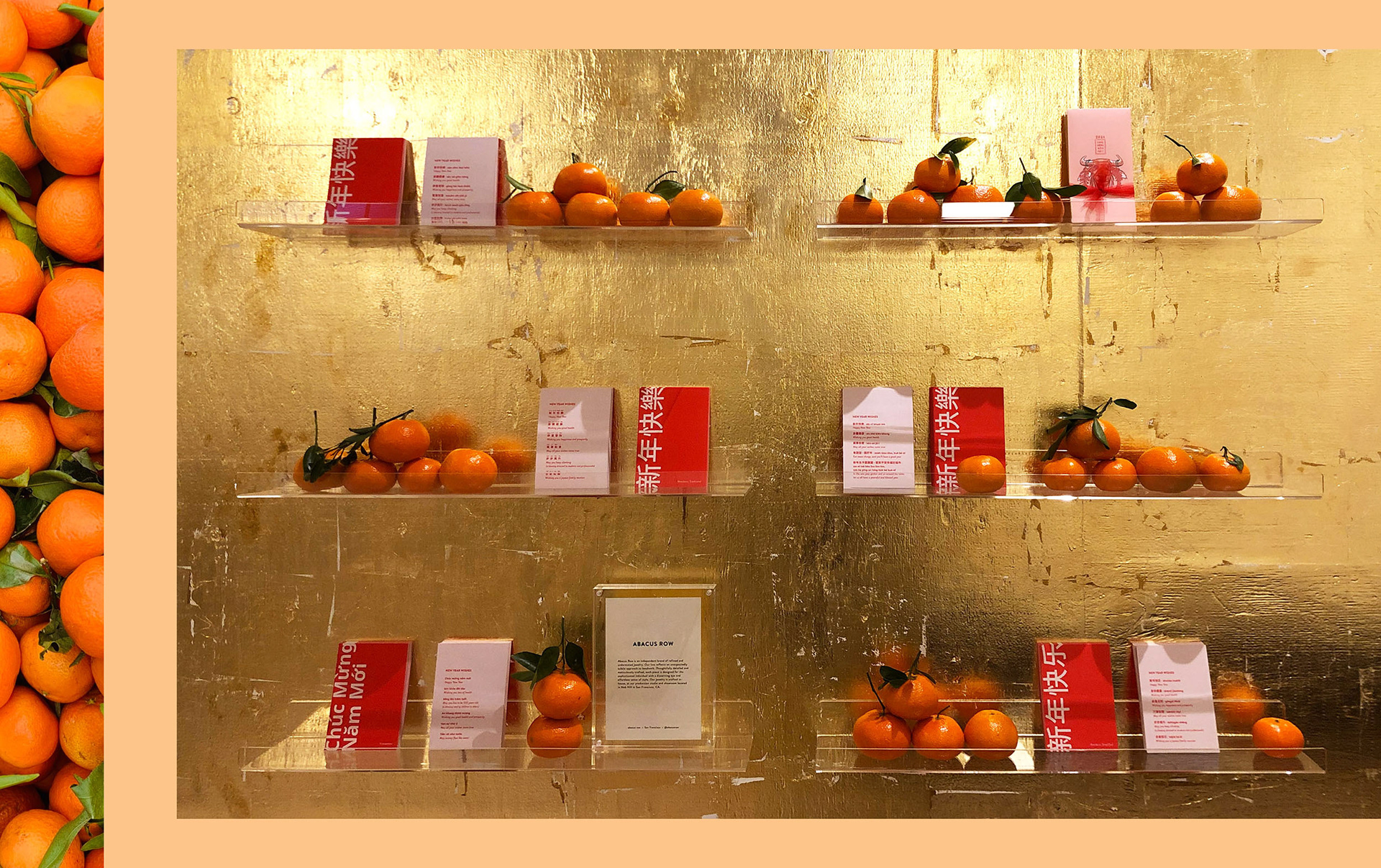 Abacus Row's shelf display with Lunar New Year postcard designs and mandarins
