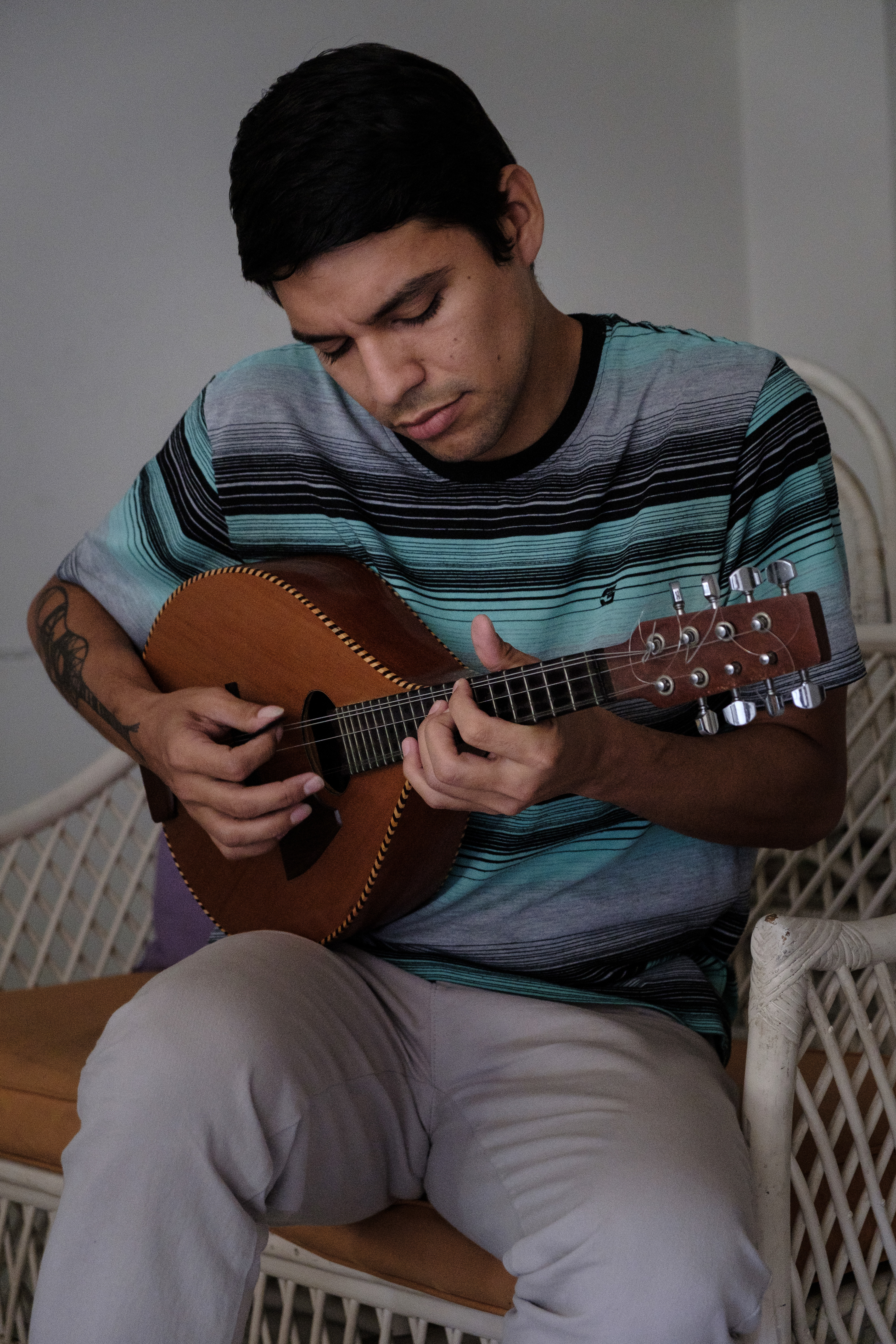 Jose David playing his mandolin even with missing strings. Originally, He was a mandolin player but then he grew love for the cuatro and now he plays both, even though the mandolin is missing strings he found the way to keep playing with it. Caracas, april 5, 2019.