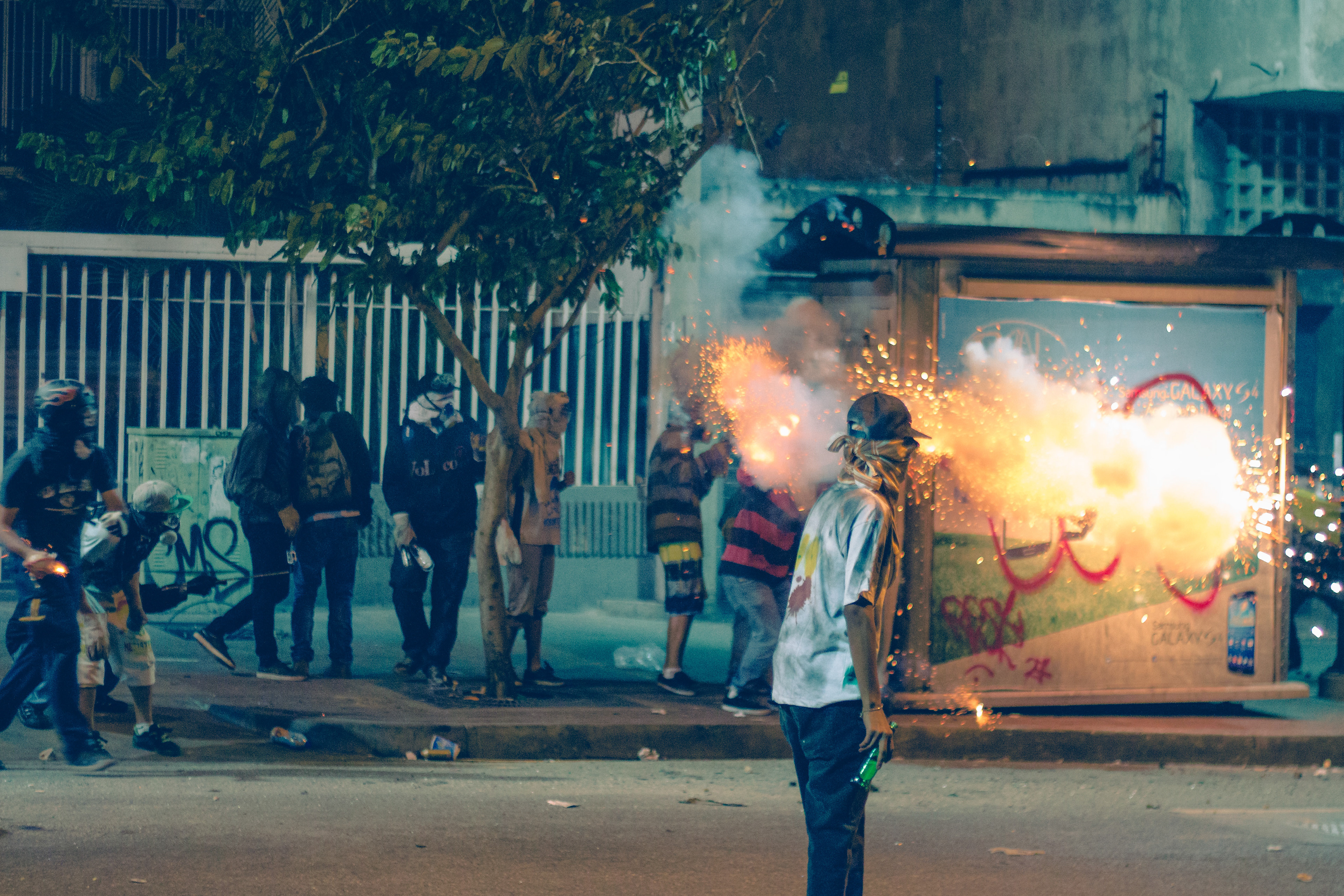 Protesters shooting fireworks at the police with an improvised cardboard tube. Caracas 2014