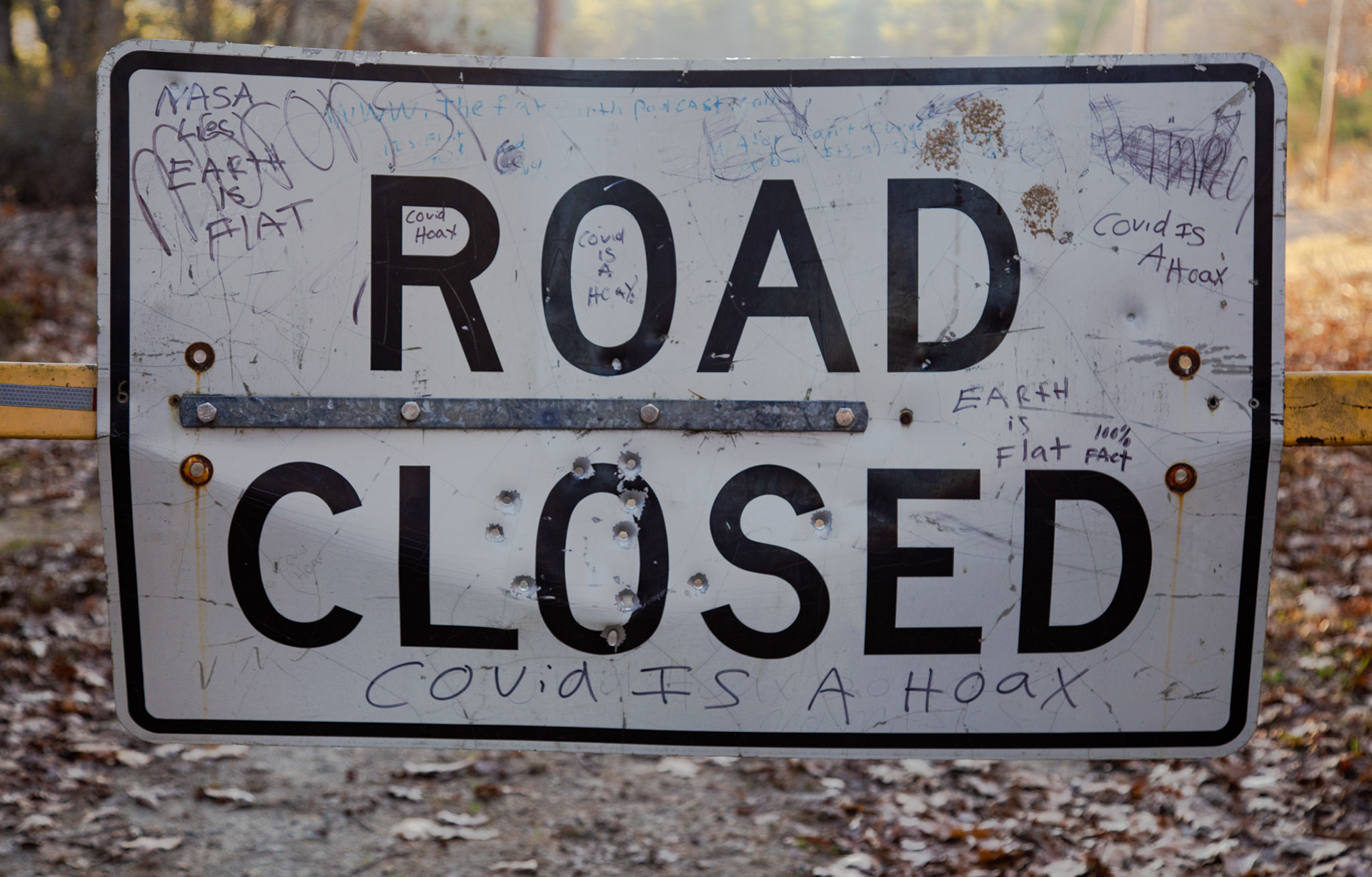 A road sign is full of graffitied conspiracy theories as Covid rages on. Templeton/Baldwinville, MA. 