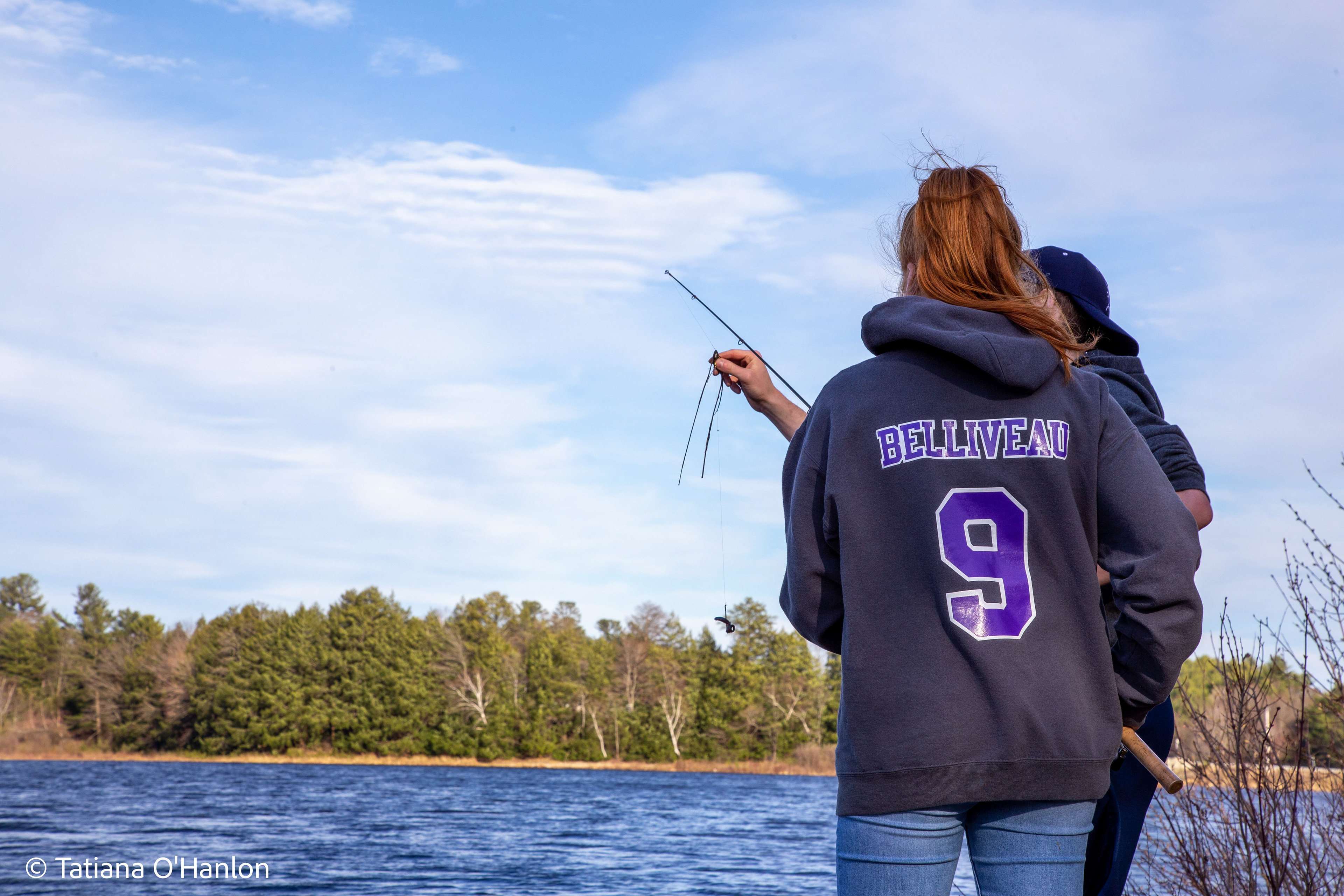Two siblings go fishing together on a nice day