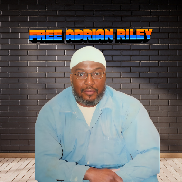 A picture of Adrian Riley wearing a light blue shirt with the text "Free Adrian Riley" above his image