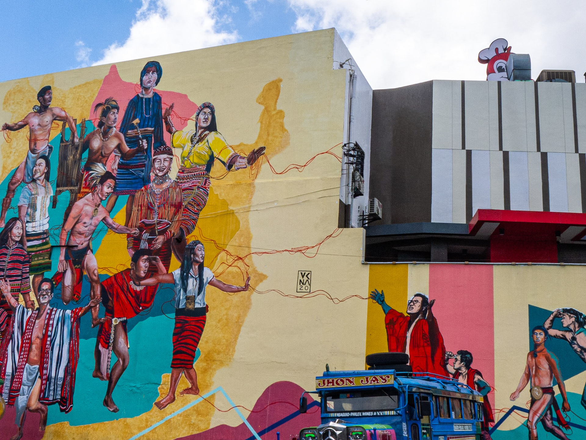 Are they looking for Jollibee? 😊. Galeng nya magtago 😁. : : -------- From my PIX THAT SPIX Series | Images that speak. © 2021 Photo by Alexander V Pascual. Mural artwork by Venazir Martinez. -------- #lumix #photooftheday #baguio #streetphotography #people