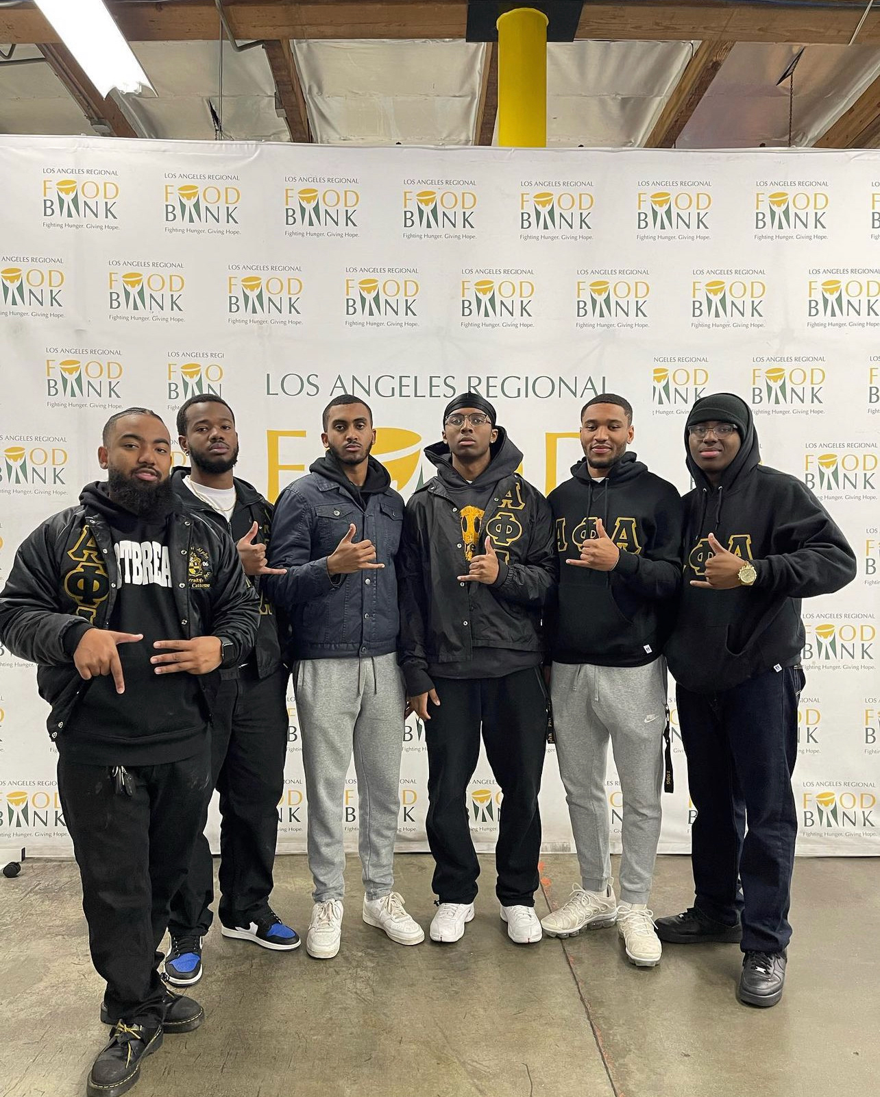 Gamma Xi volunteering at a food bank with Mu Sigma Lambda