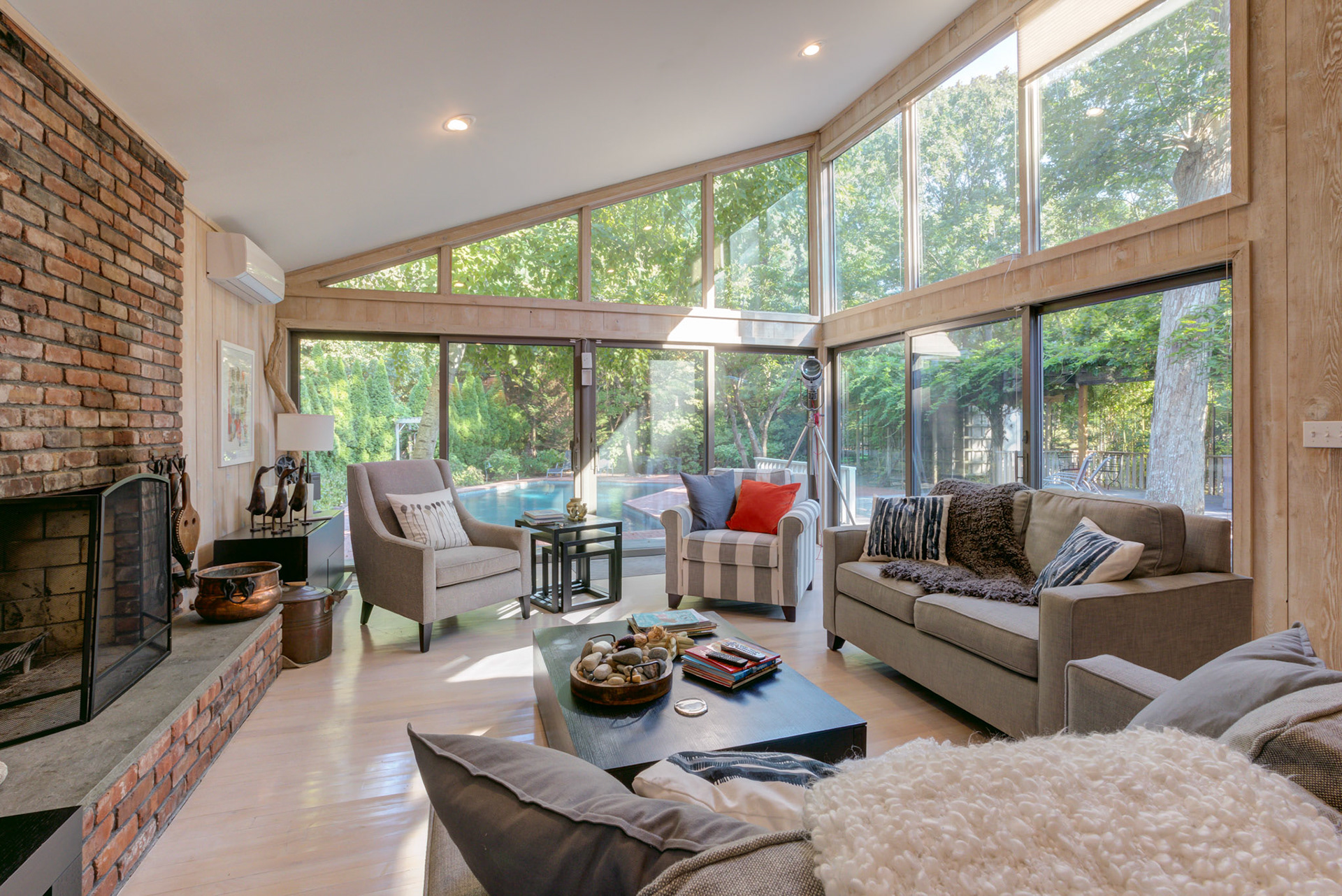 Professional photo of modern living room with outside views to pool and patio