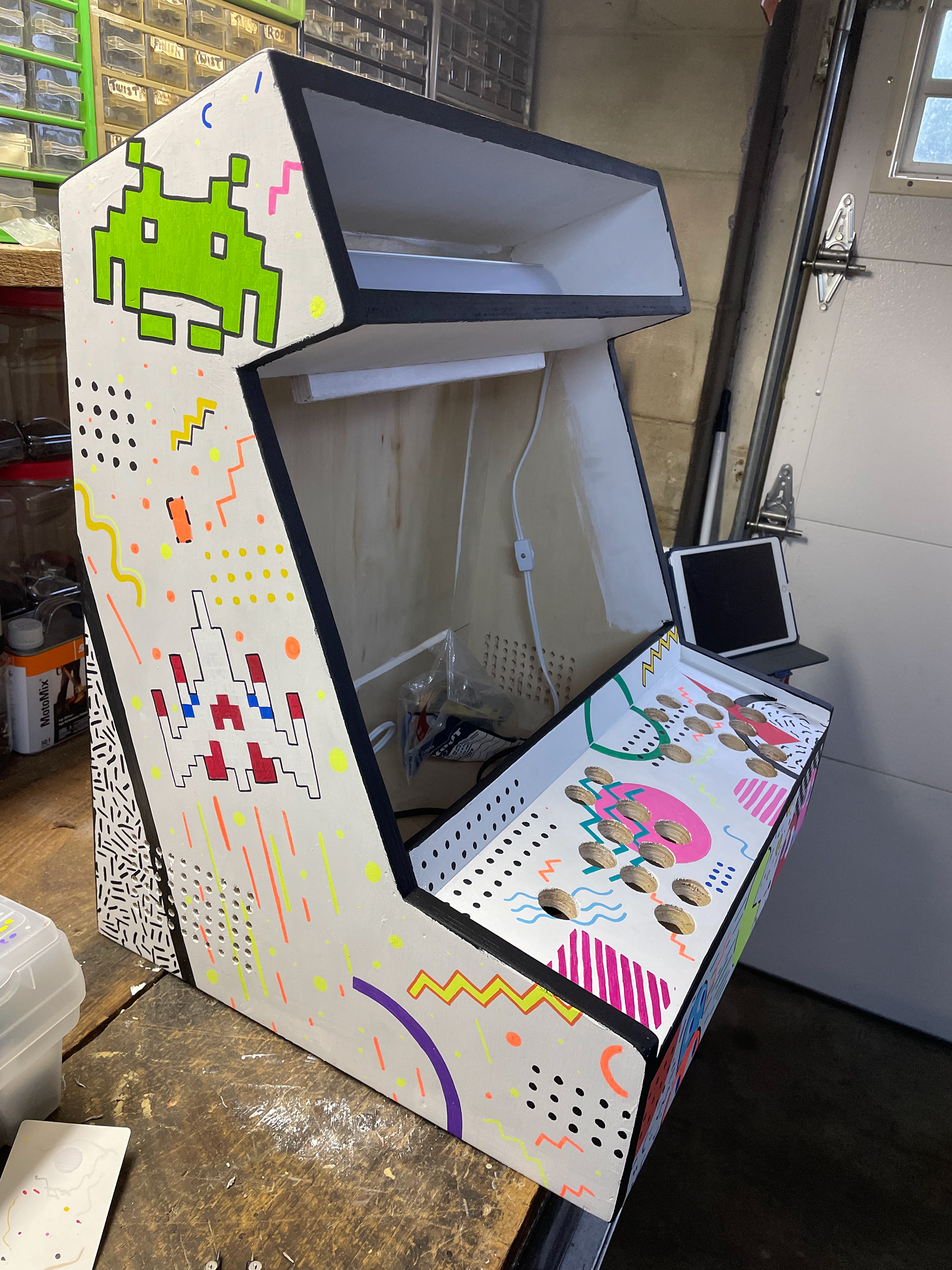 Cabinet's right side. I wanted to go for the Memphis art style of the 80s due to the zany patterns and vibrant colors.