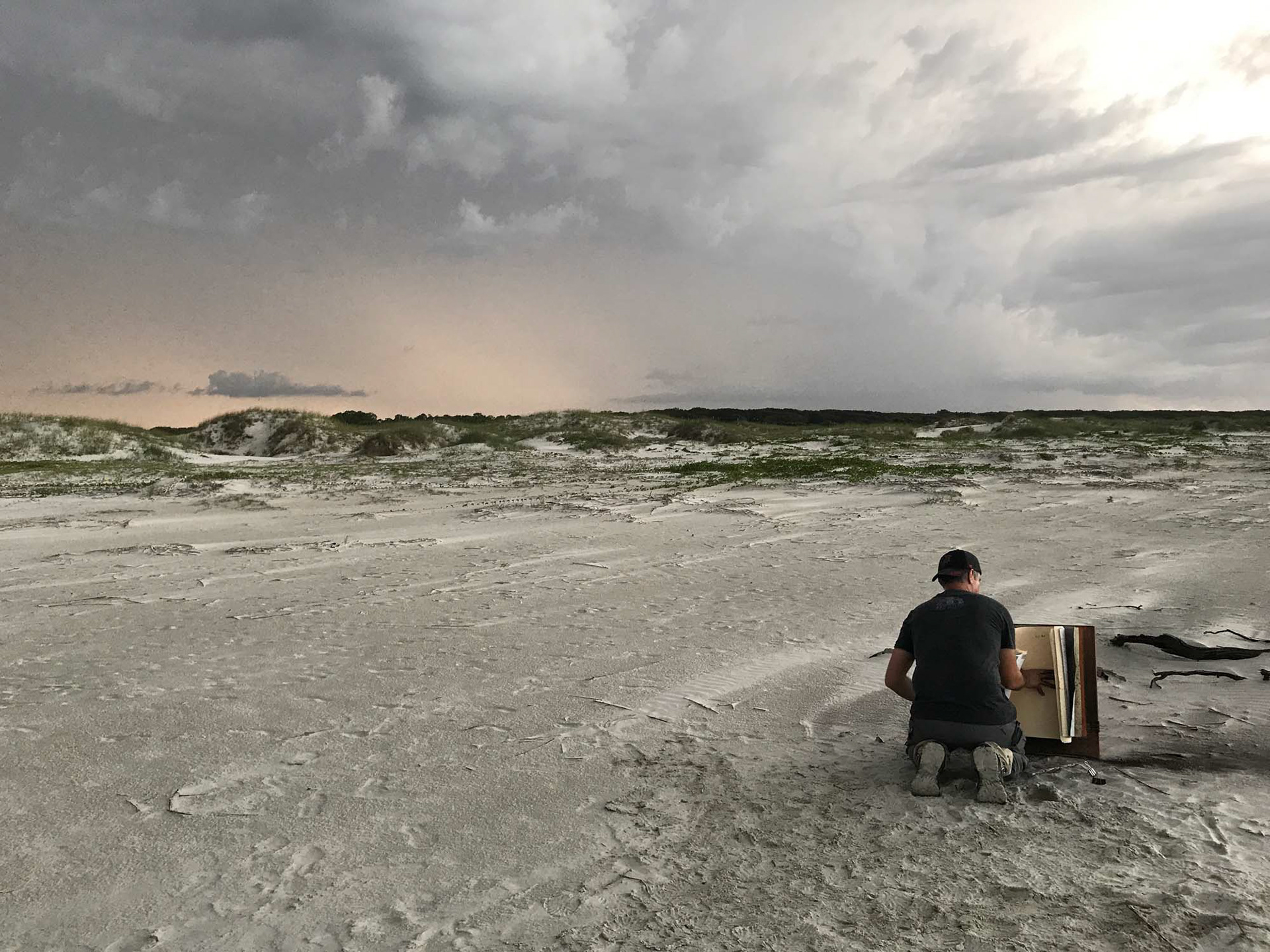 Ernesto drawing at sunset