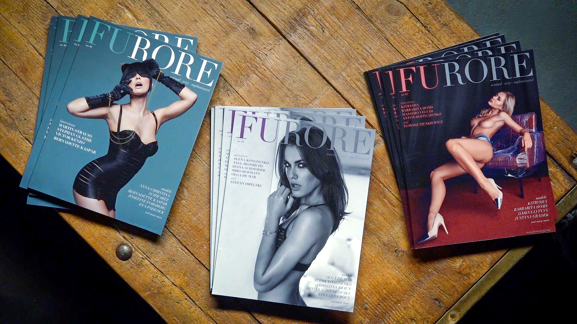 Printed copies of FURORE Magazine stacked on wooden table, independent editorial photography magazine print edition