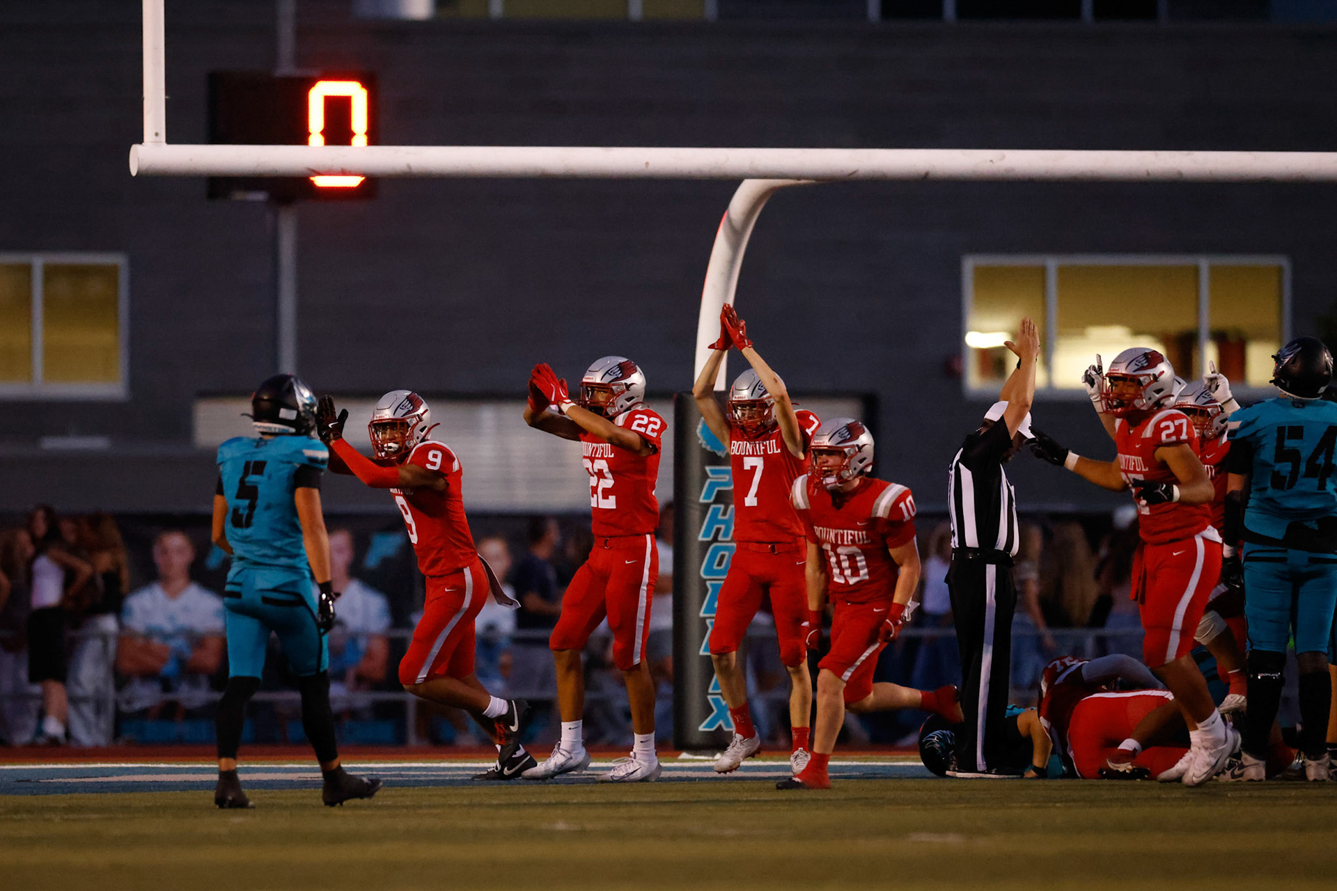 Bountiful Redhawks' Defense celebrates a safety in the third quarter to put Bountiful's lead at 7-3 heading into the fourth quarter.