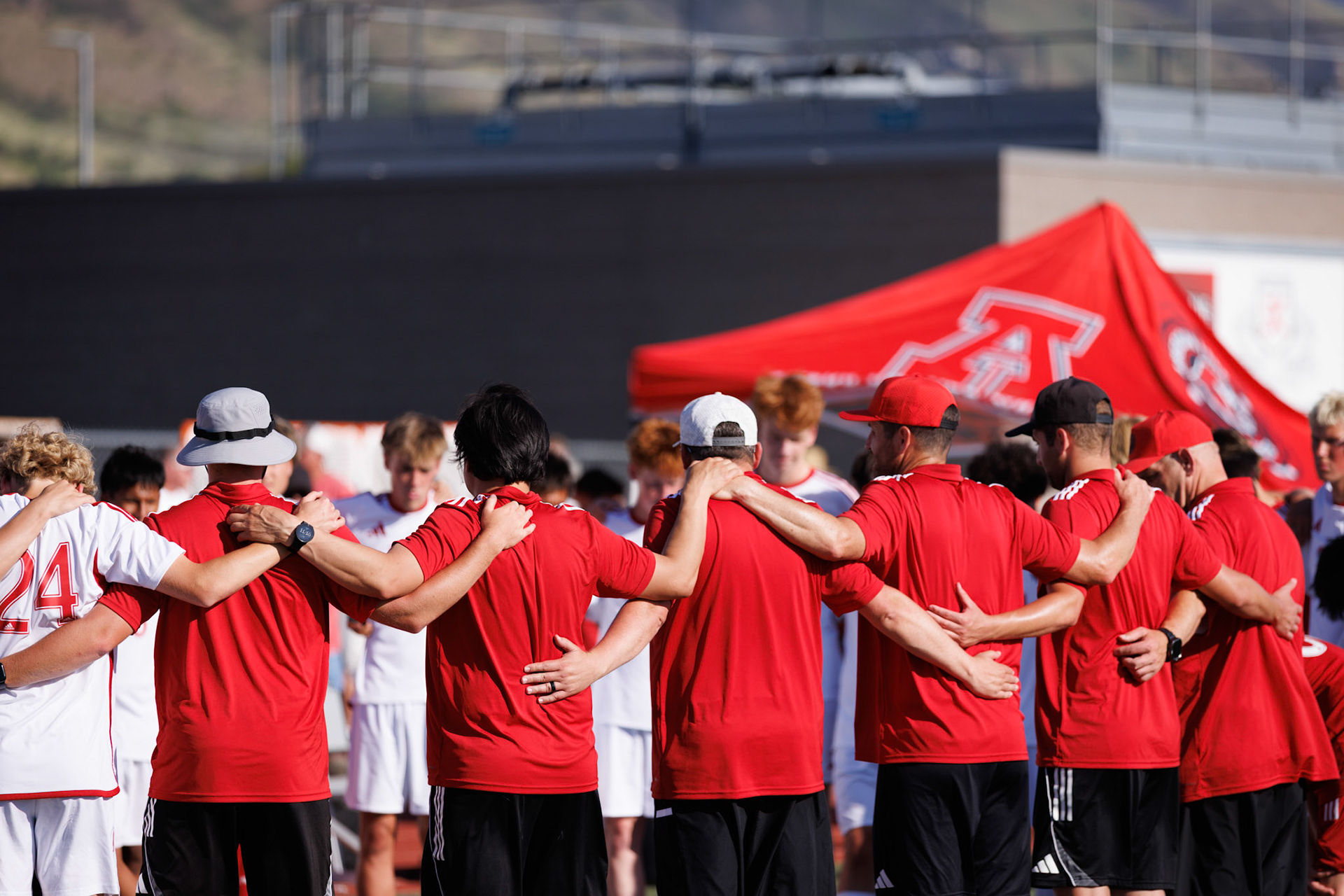 American Fork coaches address their players after a heartbreaking loss to Farmington in the first round of 6A state soccer tournament.
