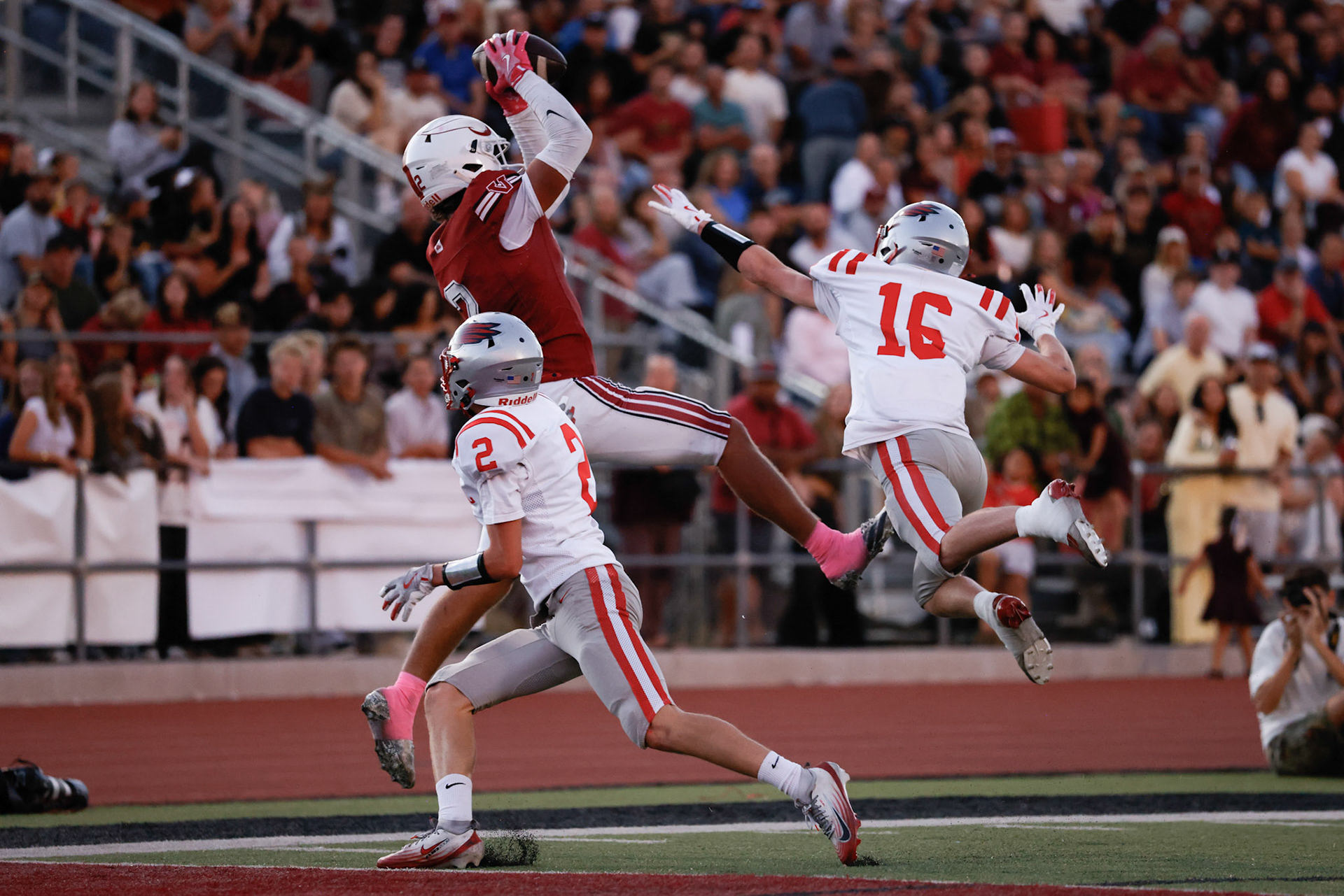 Viewmont WR Jayson Dunroe (2) makes a touchdown catch over Bountiful defenders Tyce Budge (2) and Mason Tidwell (16) to put the Vikings up 7-0 in the first quarter.