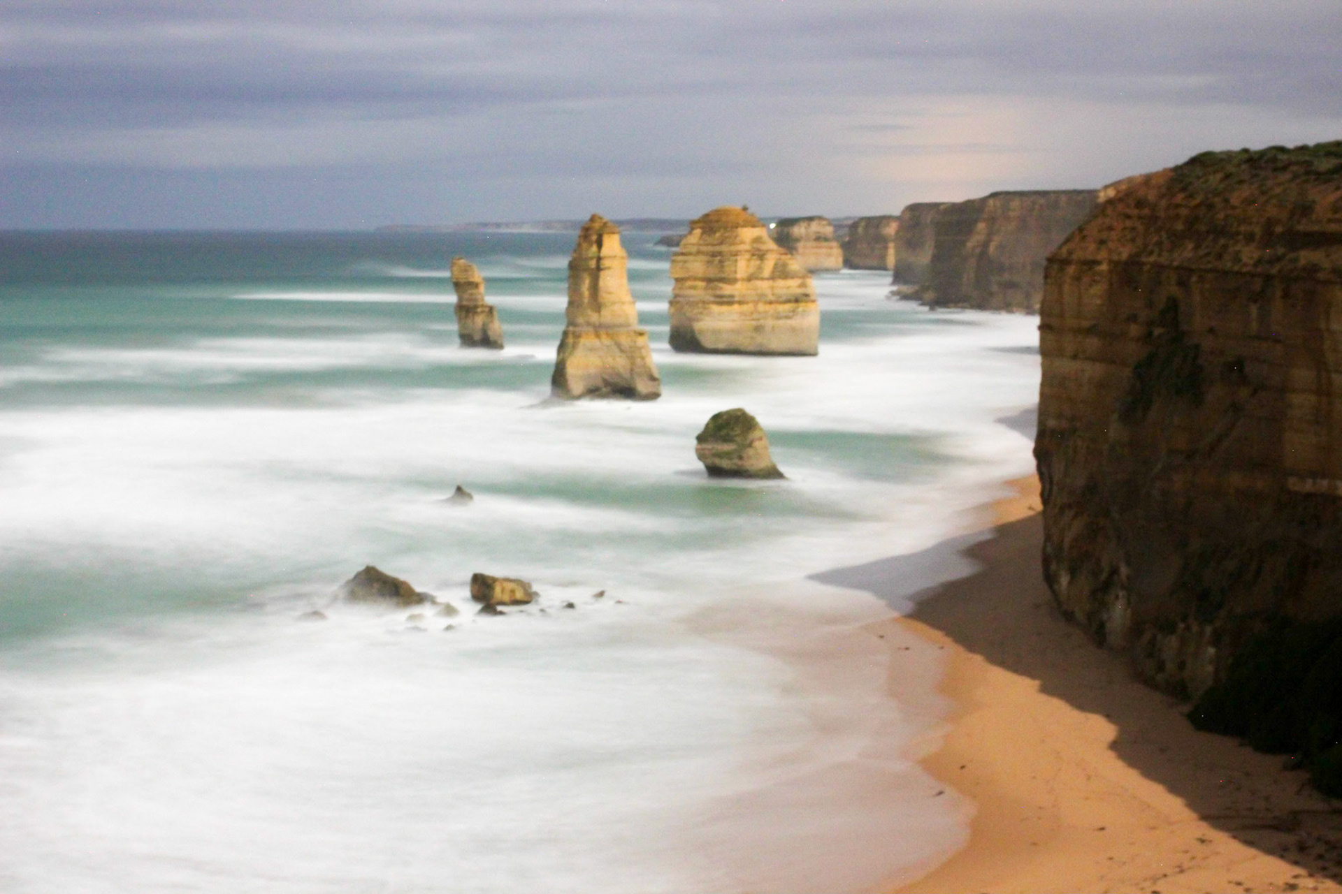 Moonlight opens a clear view of one of the most visited year-round landmarks rising abruptly from the tempestuous Southern Ocean waves in Australia, the Twelve Apostles.