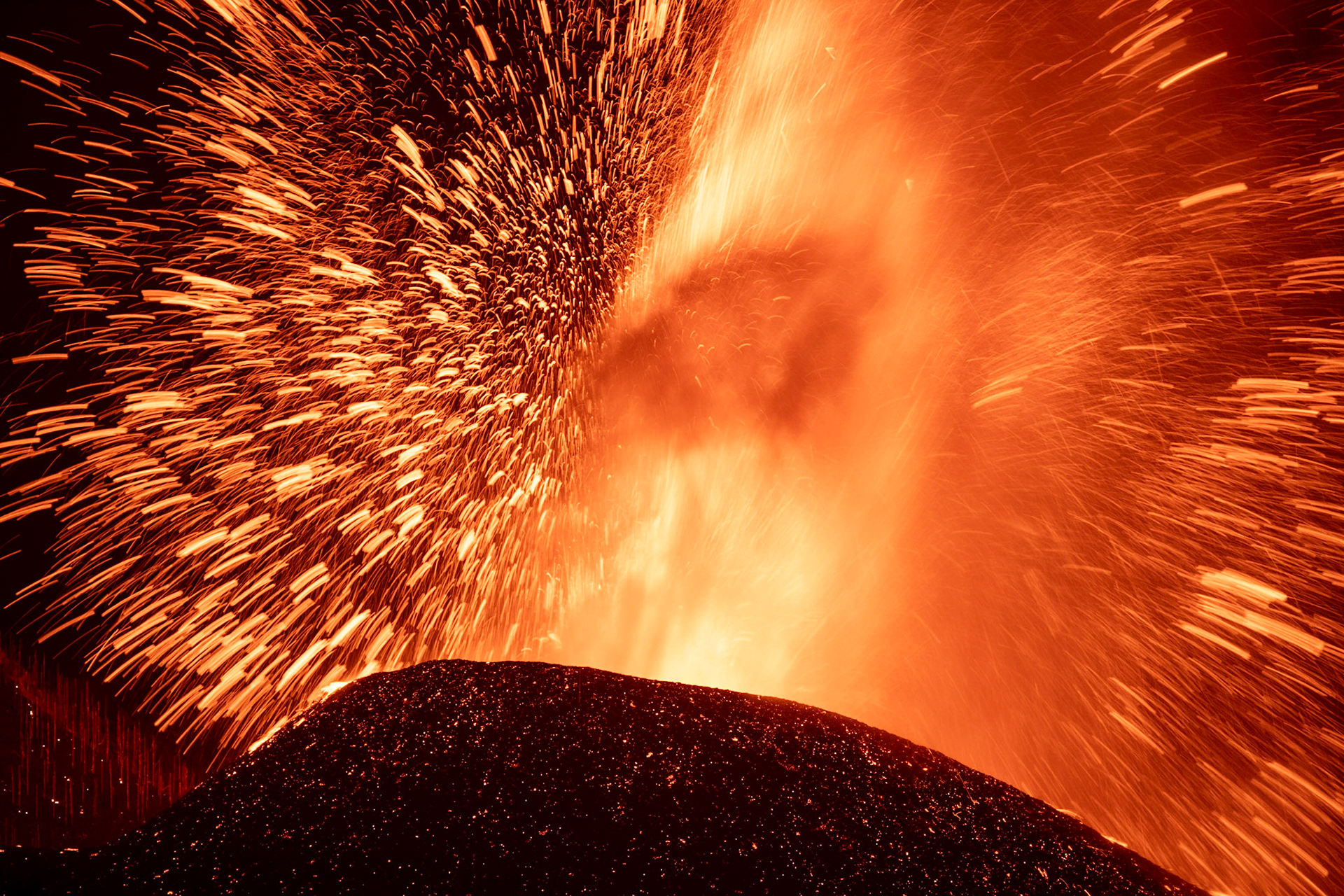 The explosive volcanic eruption of Cumbre Vieja. Sudden releases of gases from magma explode and cause rapid movements of the molten rock that look as shooting stars. La Palma, Canary Island, Spain, September 2021.
