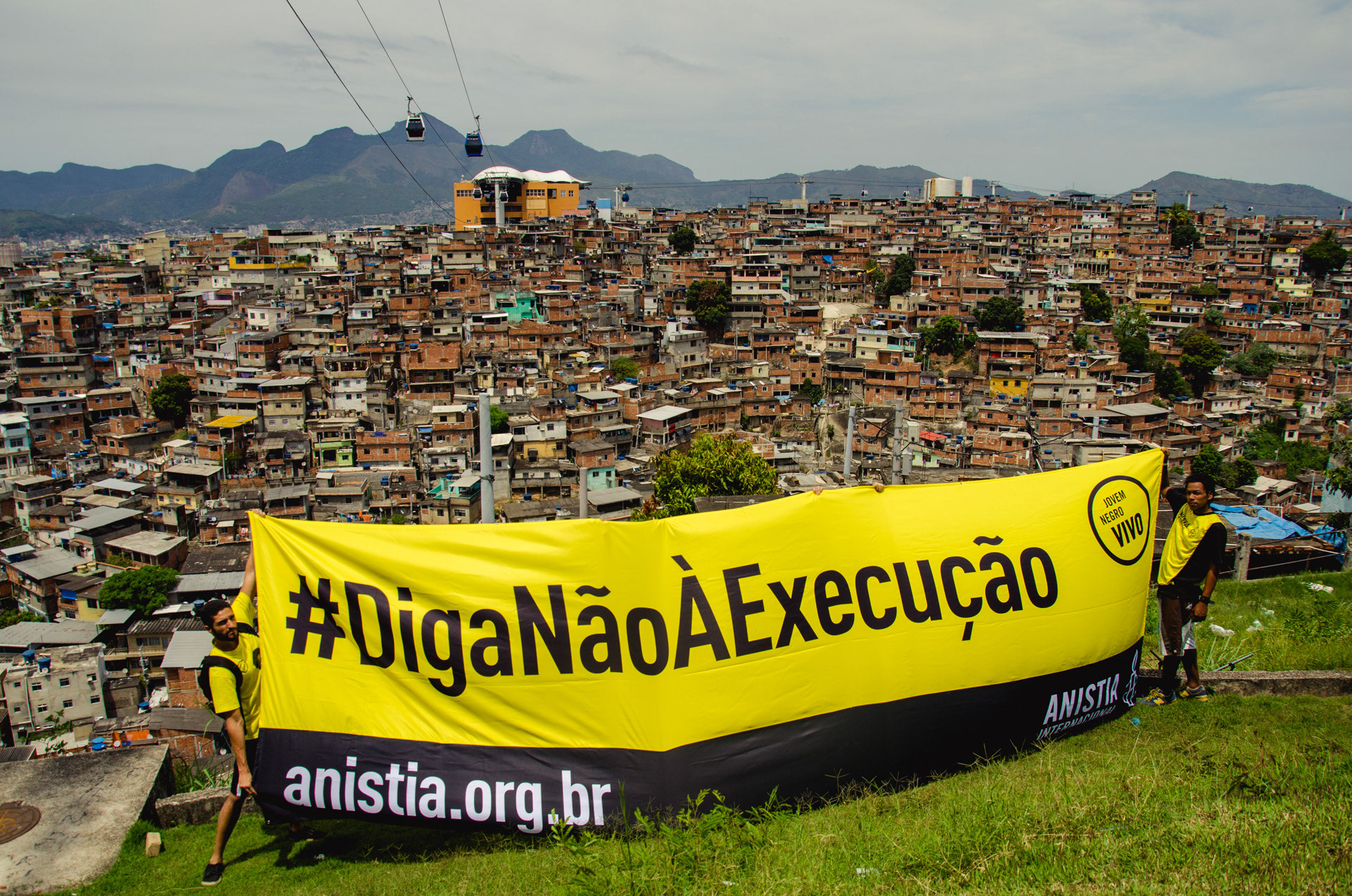 Activists hold a sign 'Say No To Execution' in the Complexo do Alemão favelas in Rio de Janeiro, Brazil - Oct 2015