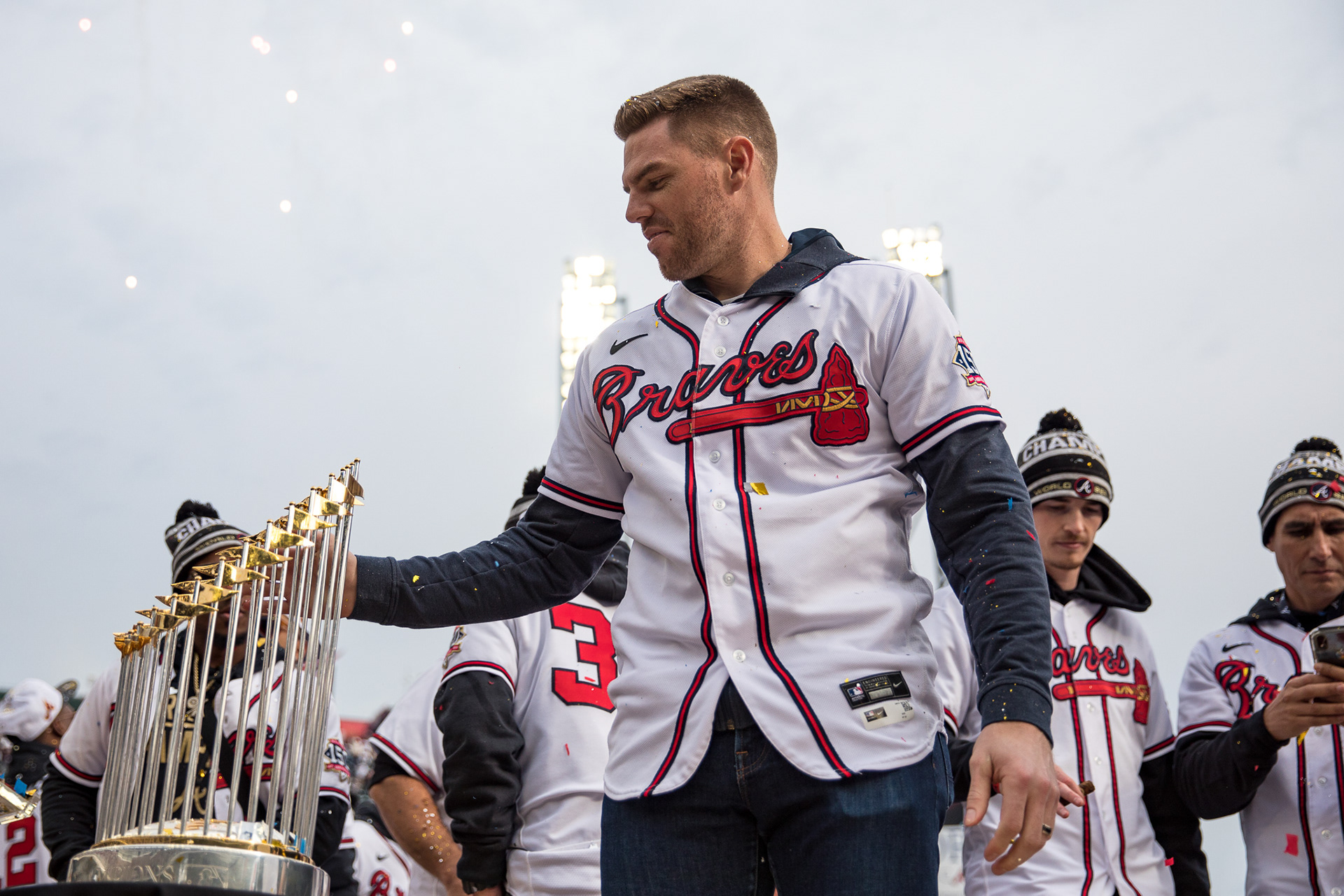 Braves player Freddie Freeman accepts the World Series trophy during a celebration of the team's World Series win.
