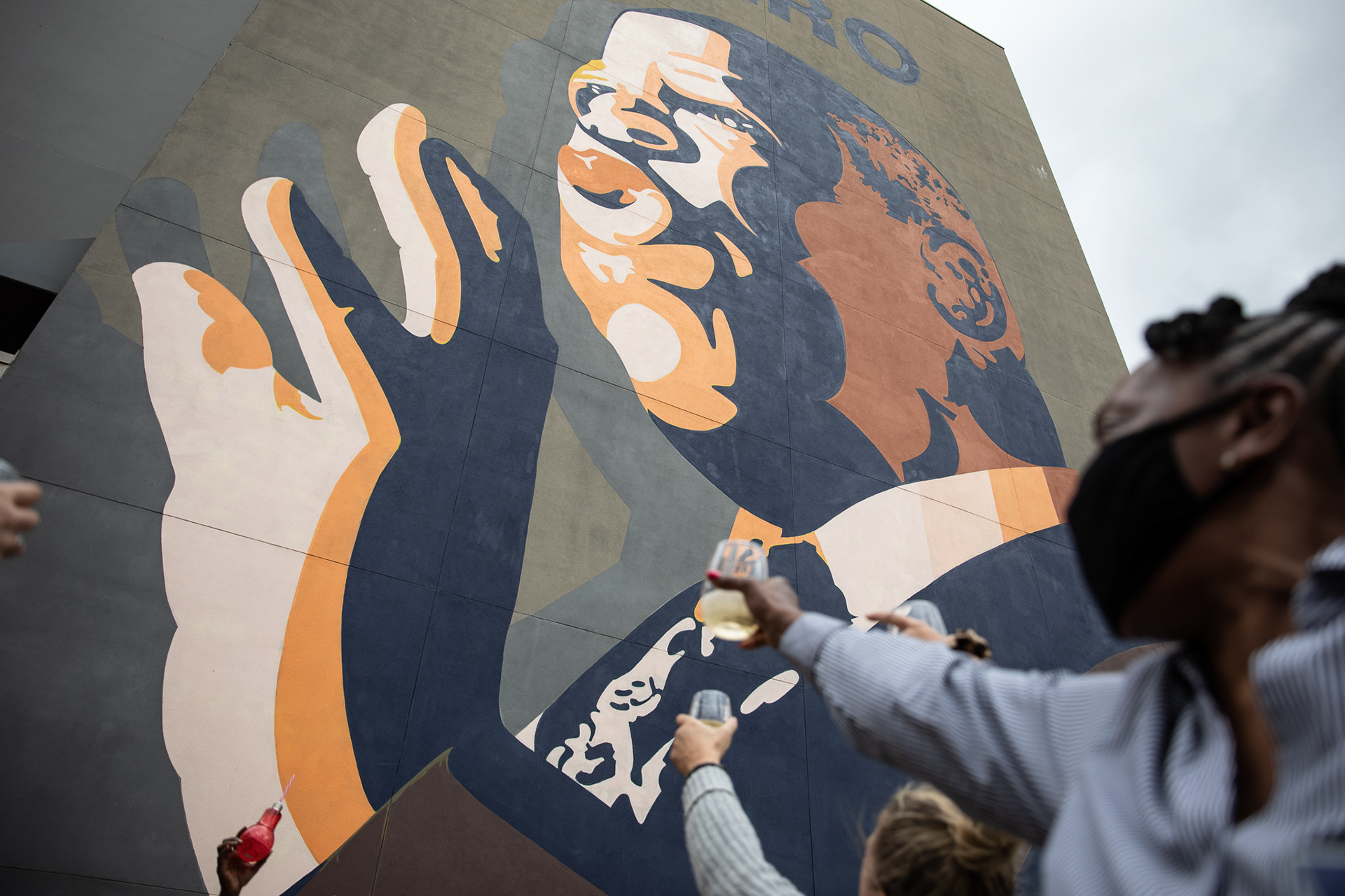 A small group raise a champagne toast to the mural of the late Congressman John Lewis in Atlanta on Nov. 7 after it was announced Joe Biden would be the next president. 