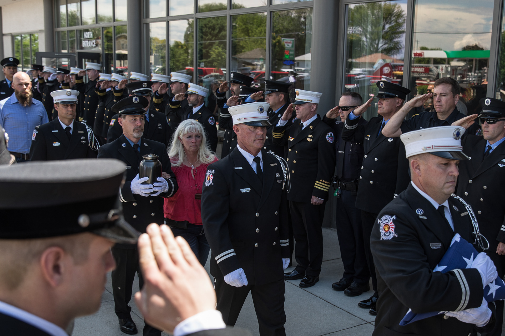 Uniformed personnel on Saturday escort the family of Boise Senior Firefighter Charlie Ruffing from the Nampa Civic Center, after a memorial service in his honor on May 31.