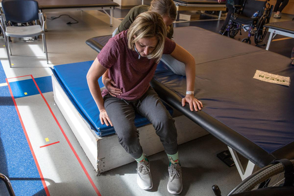 Nikeela Black practices transfers during physical therapy at Craig Hospital in Englewood, Colo., on Oct. 17.