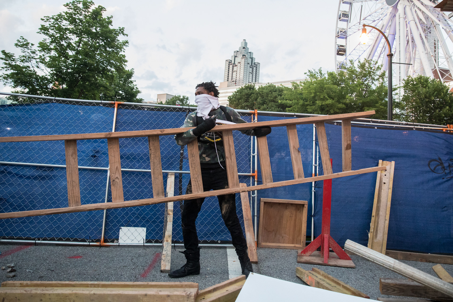 An offshoot of protesters attempt to build a baracade with wood and chain link fences grabbed from a bordering contruction site in downtown Atlanta on May 31.