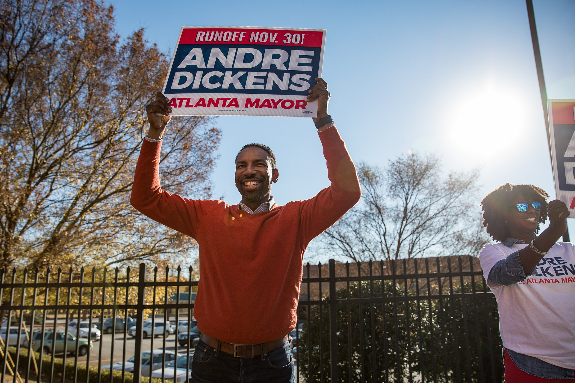 City Councilman Andre Dickens holds a sign outside of a polling location as voters cast their ballots in the Atlanta Mayor runoff.