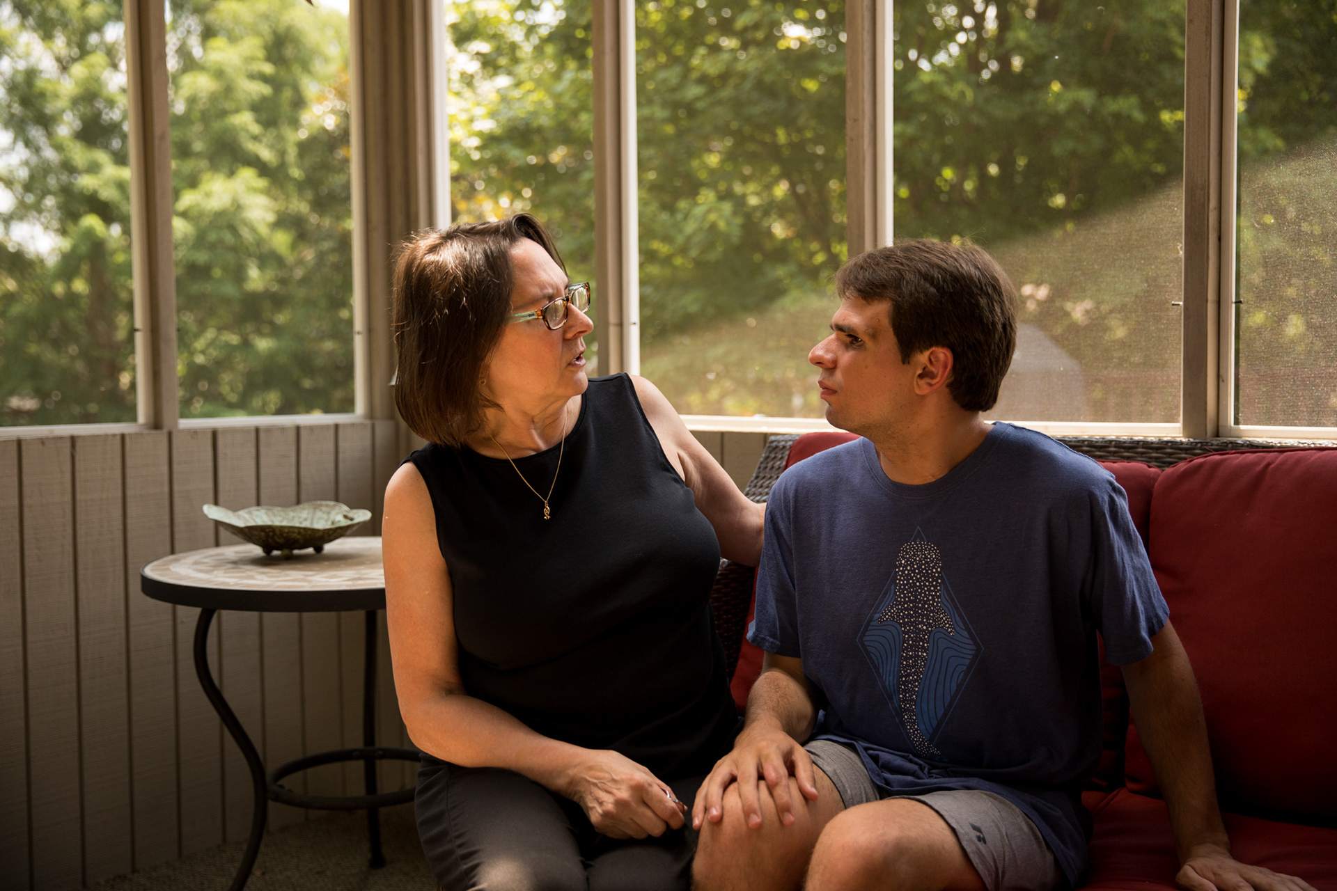 Lisa and Evan Woody converse in the sun room of their house in Dunwoody on July 18.