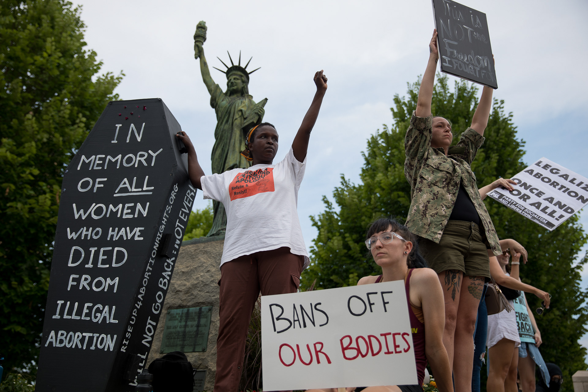 Protesters stand on the statues outside of the Georgia State Capitol on June 24 to protest the Supreme Court decision to overturn Roe v Wade. Georgia’s six-week abortion ban that has been held up by a district court will likely go into effect due to the ruling.
