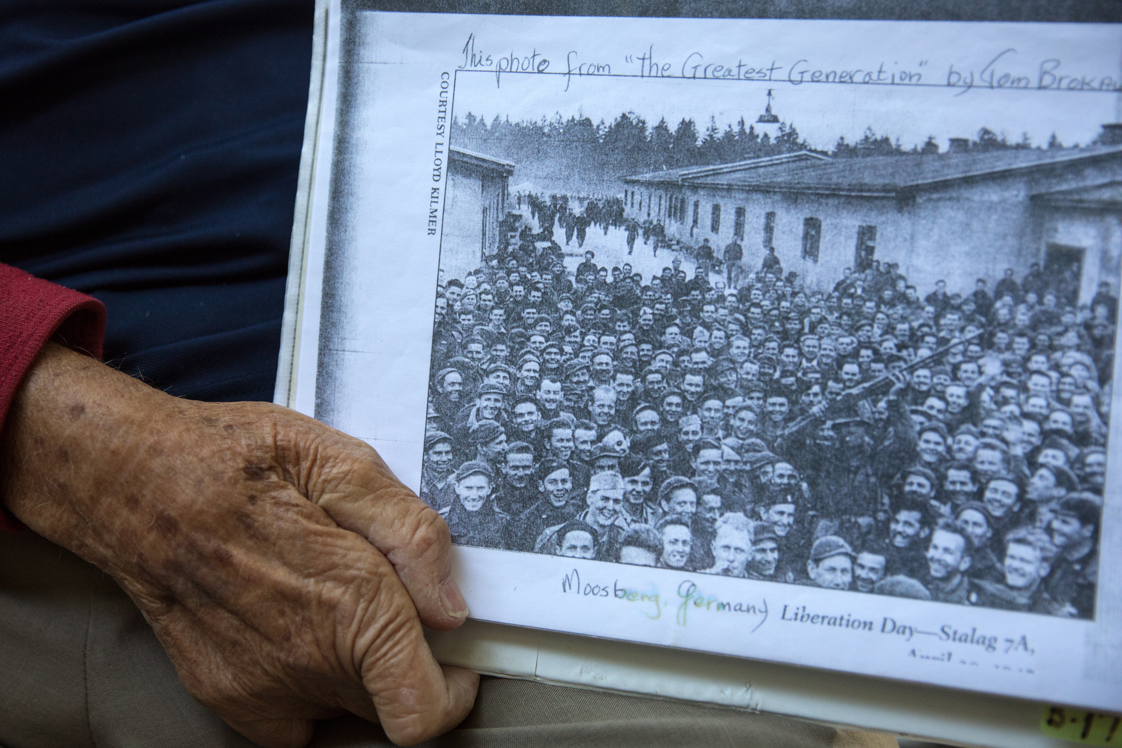 George Emerson, 93, holds a photo taken when his German war camp was liberated on April 29, 1945 on Sept. 14 in Nampa.